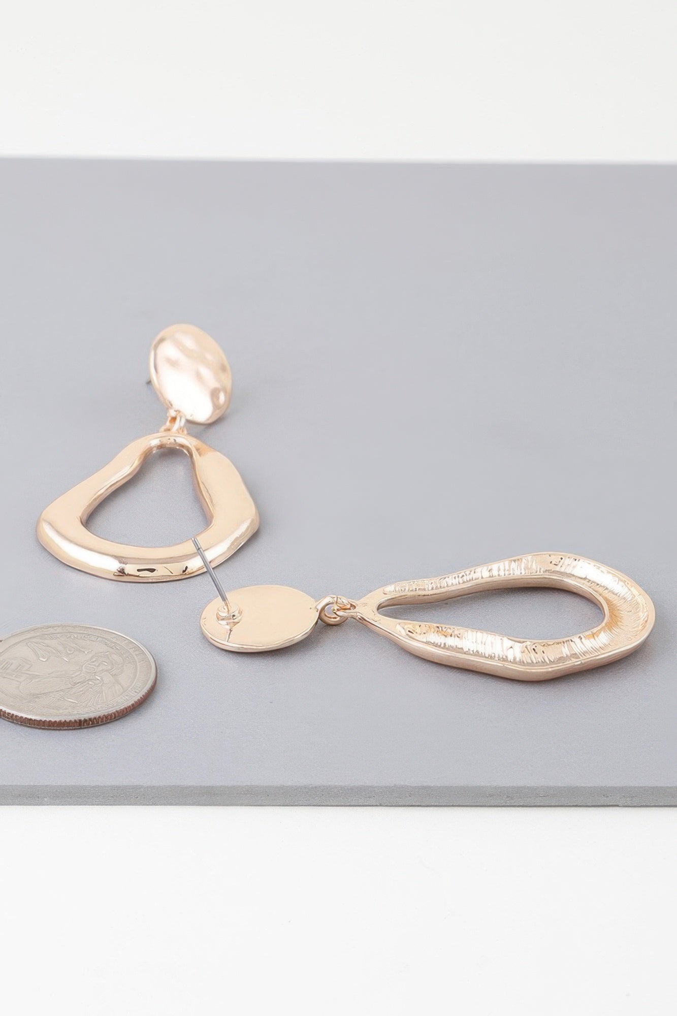 Golden Heir abstract shiny teardrop drop earrings in gold and silver with a modern, elegant design.