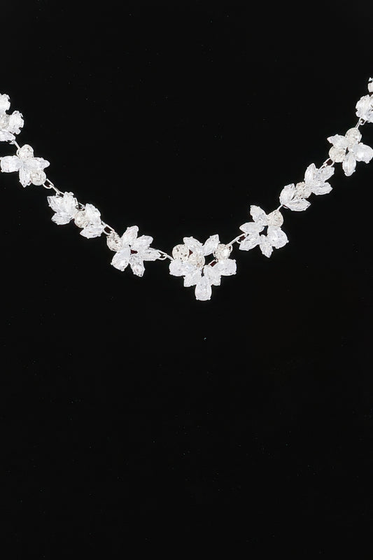 Golden Heir crystal flower charm necklace featuring a gold chain and clear crystal flower pendant.
