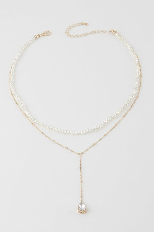 Golden Heir Aurelia double teardrop pearl necklace with cream and gold tones, featuring elegant pearl drops on a delicate chain.