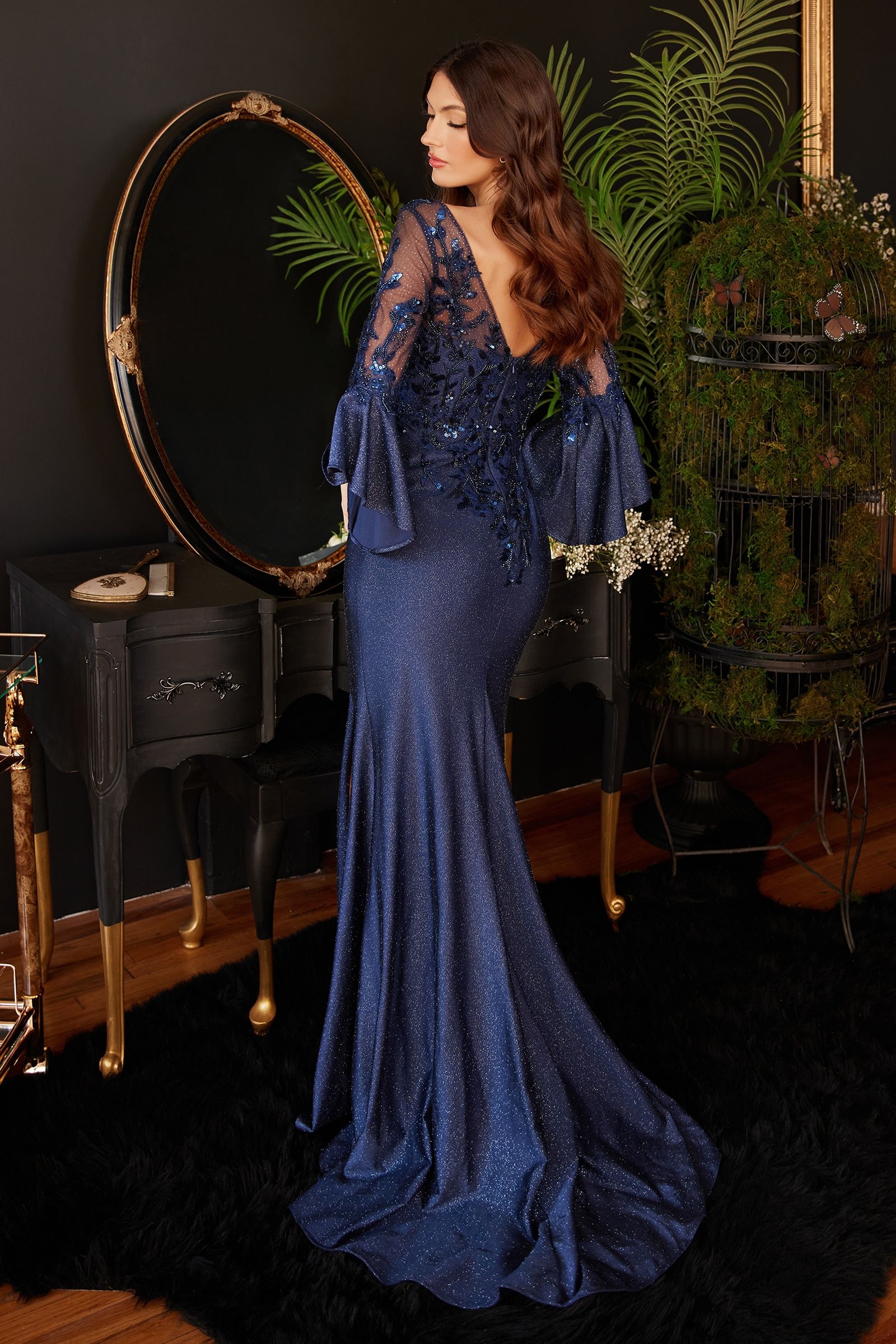 Navy long bell sleeve lace and satin gown by Tux-USA for formal events, featuring intricate lace detailing and elegant bell sleeves.