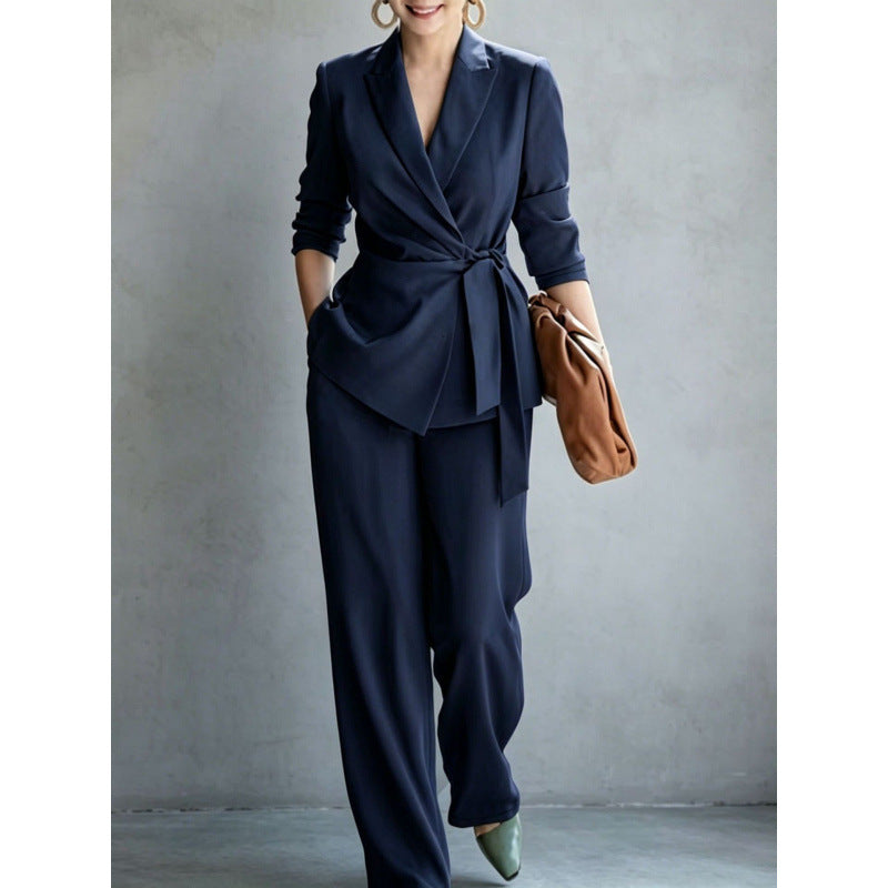 Elegant women's casual solid color suit set by eprolo featuring a belted top and matching pants.