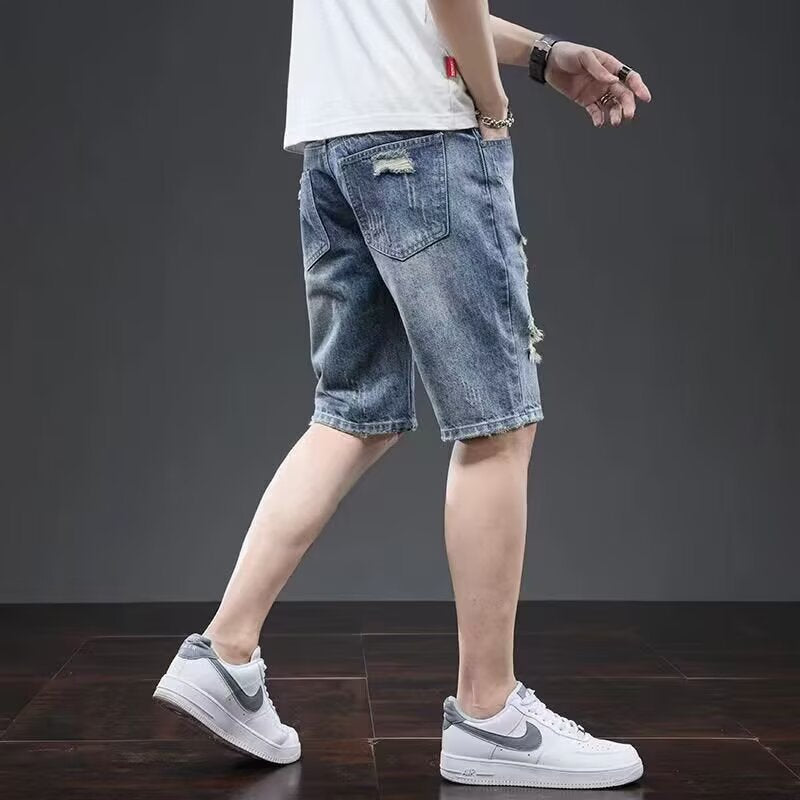 Light blue men's five-point casual ripped denim shorts by Golden Heir, styled with a relaxed fit and distressed details.