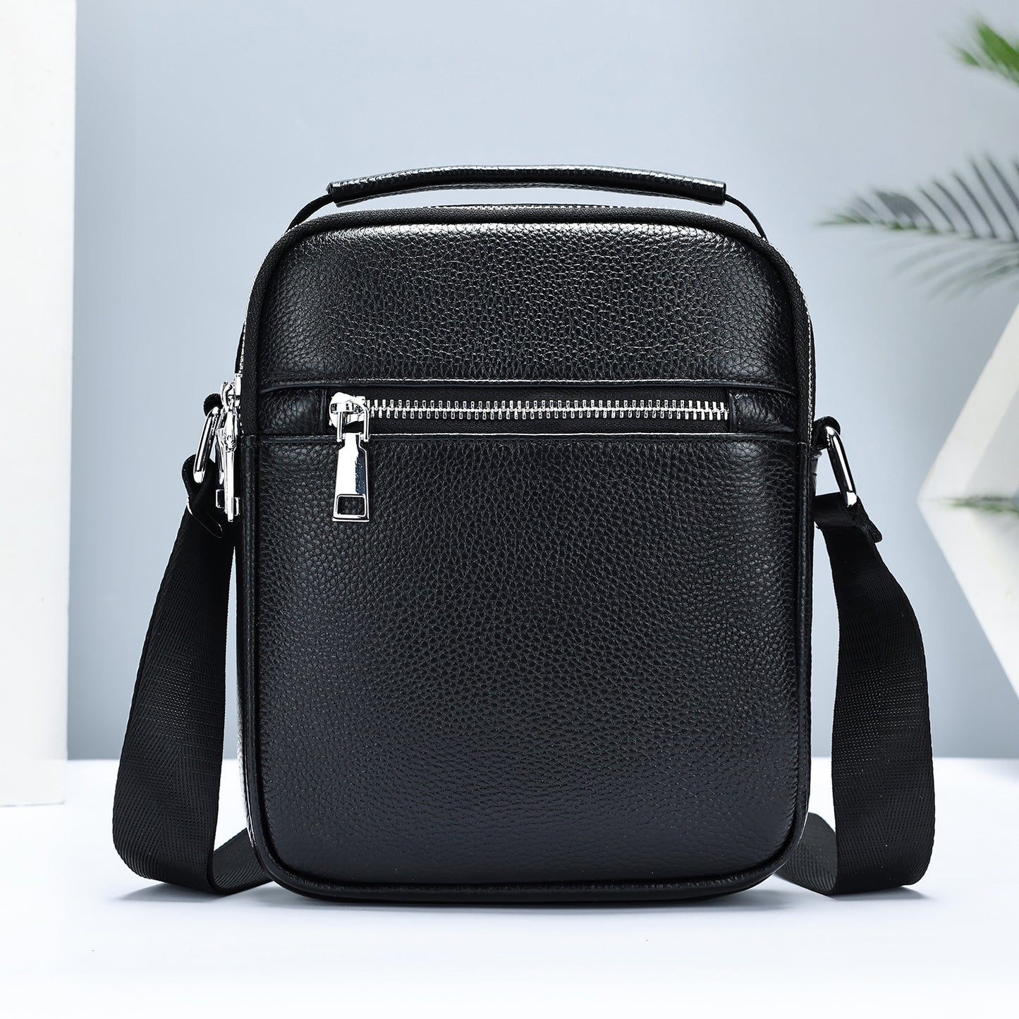 Black men's crossbody bag made from first-layer cowhide leather by Golden Heir, featuring a compact design and adjustable strap.