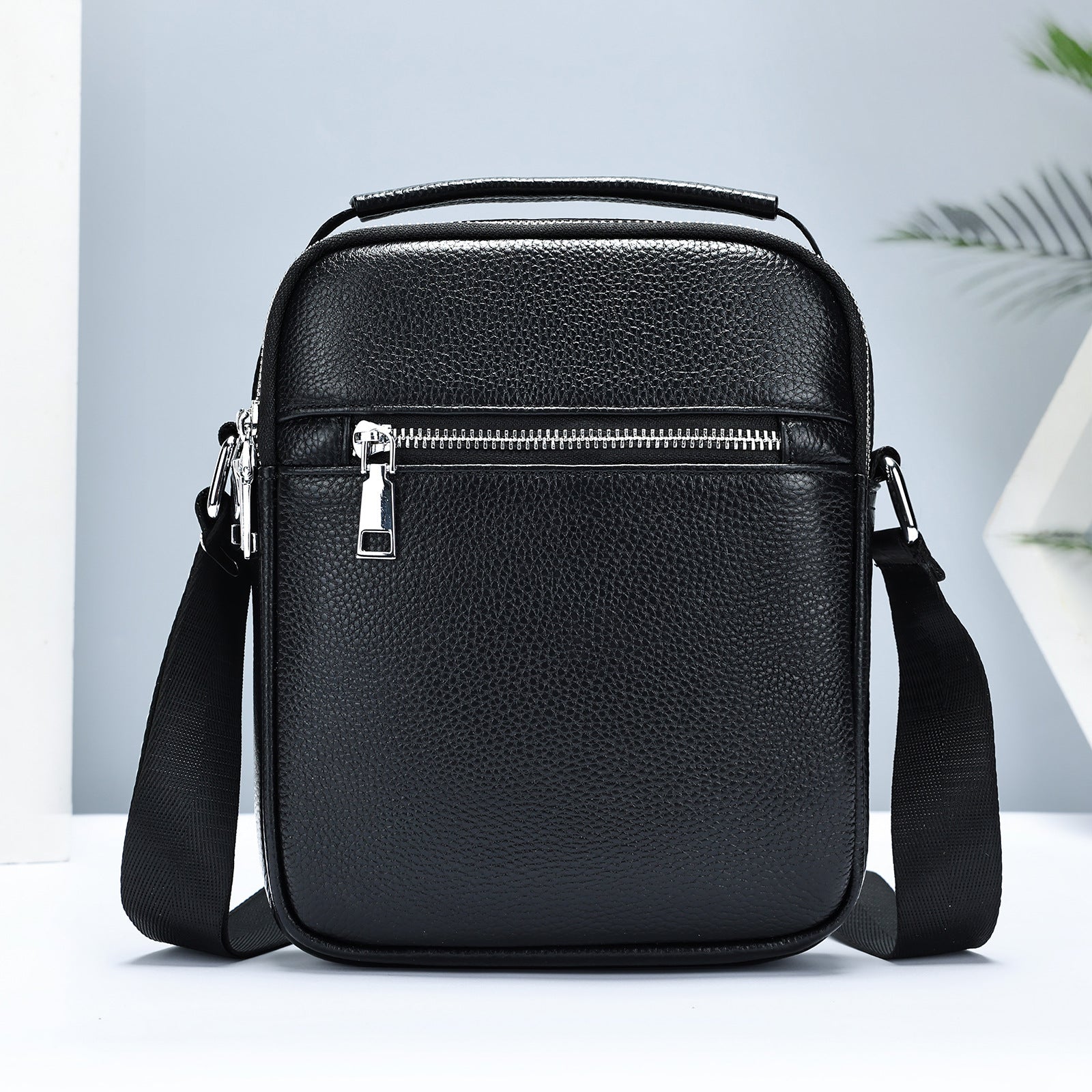 Black men's crossbody bag made of first layer cowhide leather by Golden Heir, with a compact 18x7x22cm design.