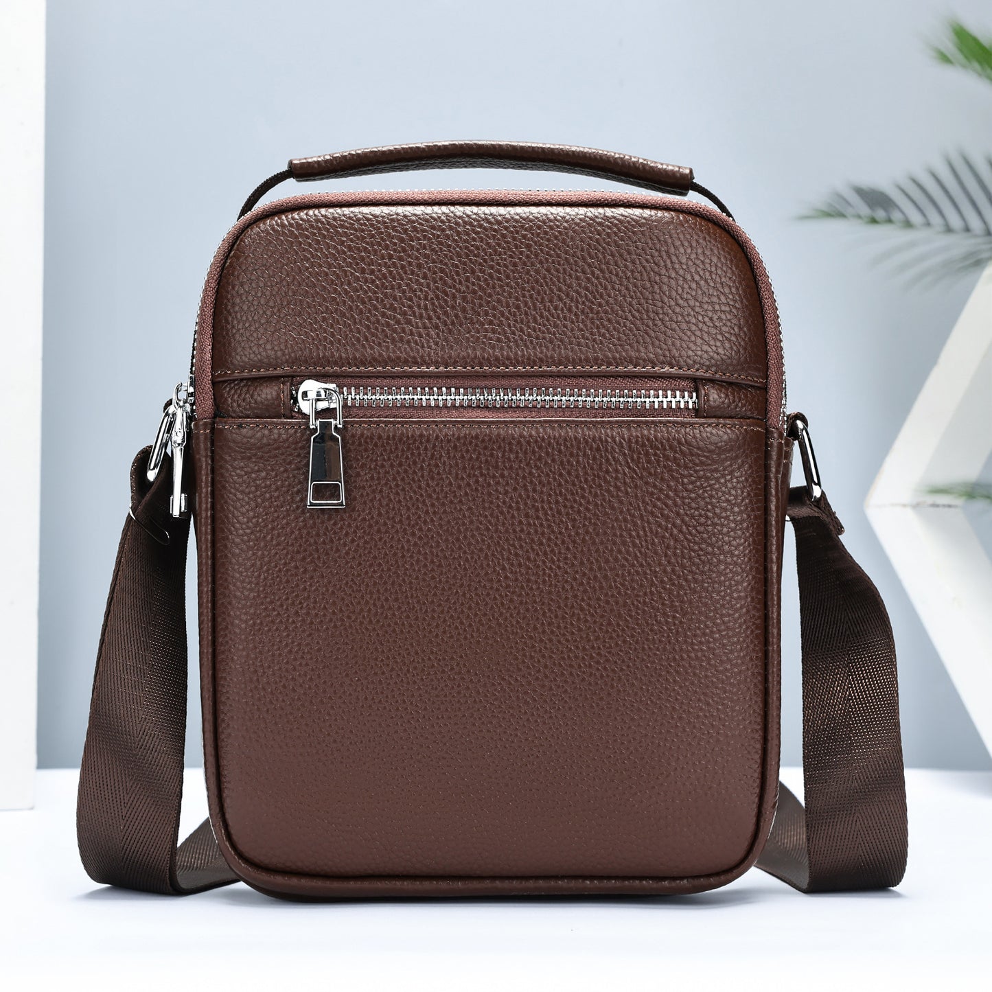 Black men's first layer cowhide crossbody bag by Golden Heir, compact bag with adjustable strap and multiple compartments.