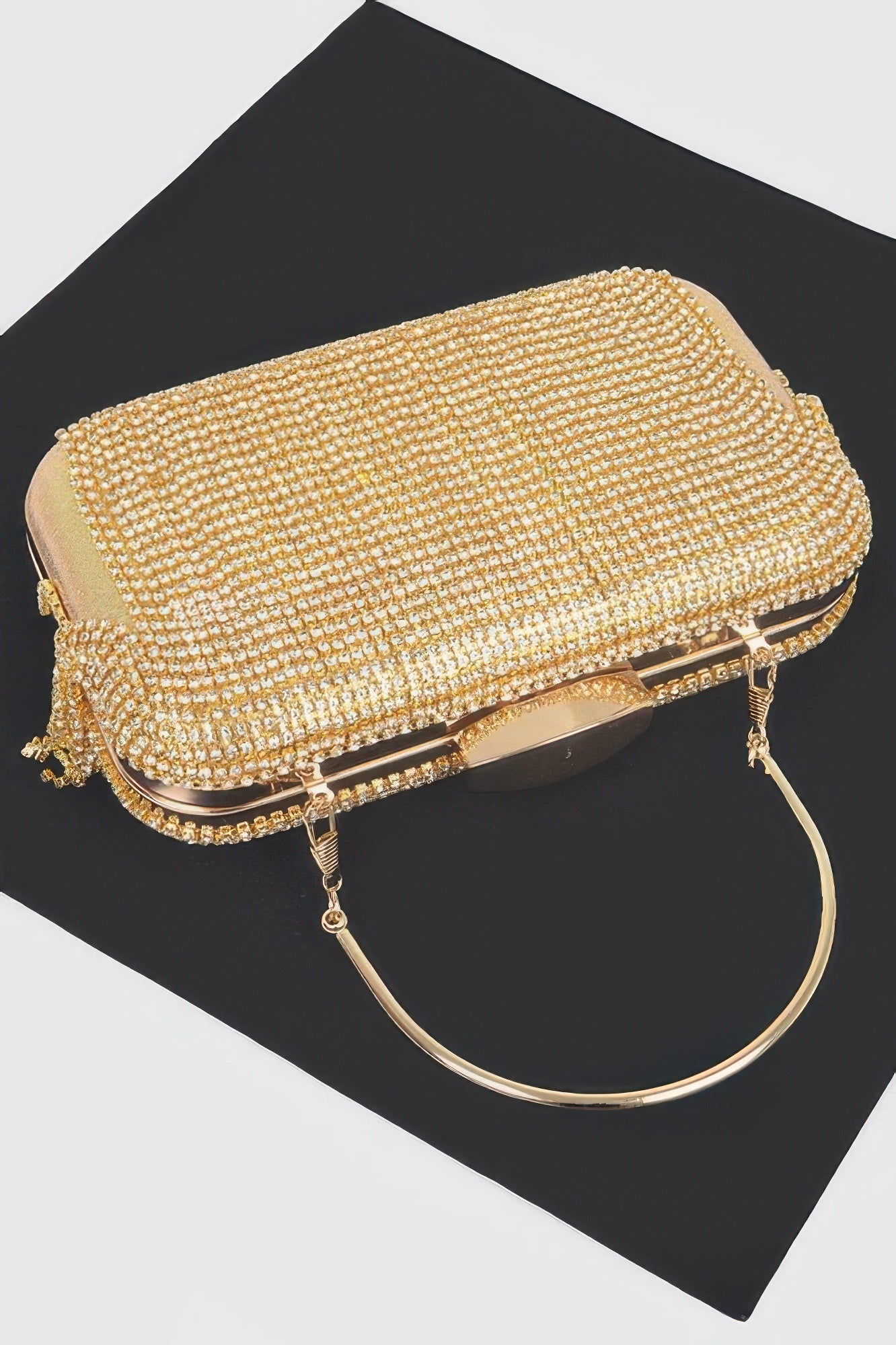 Golden Heir rhinestone fringe hard clutch bag in black with sparkling embellishments and a sleek, structured design.
