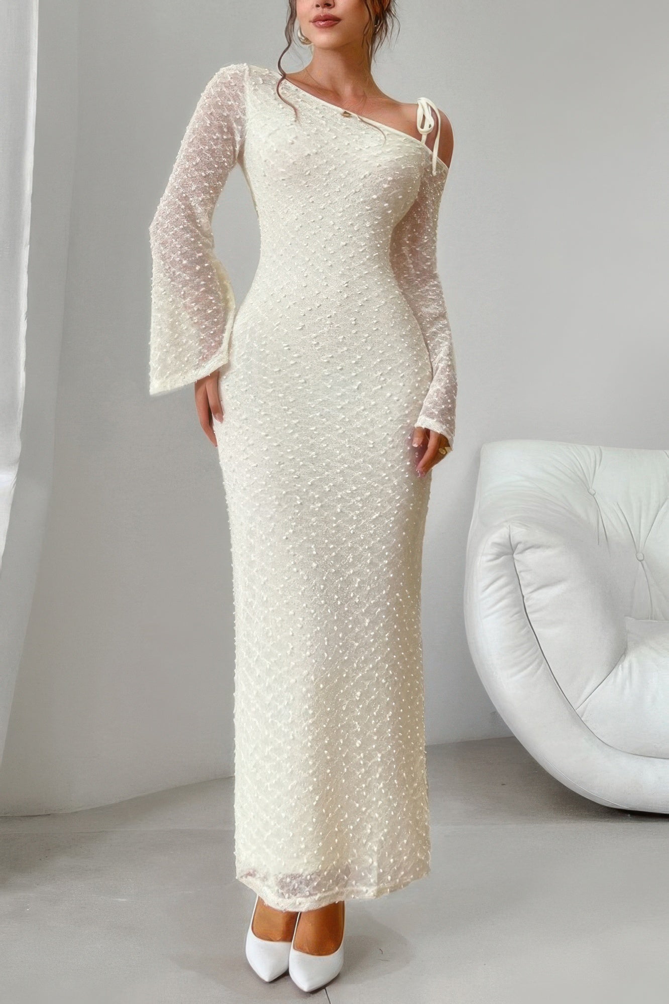 Golden Heir beige off-shoulder sculpt bodycon midi dress displayed on a model, highlighting its fitted silhouette and elegant design.