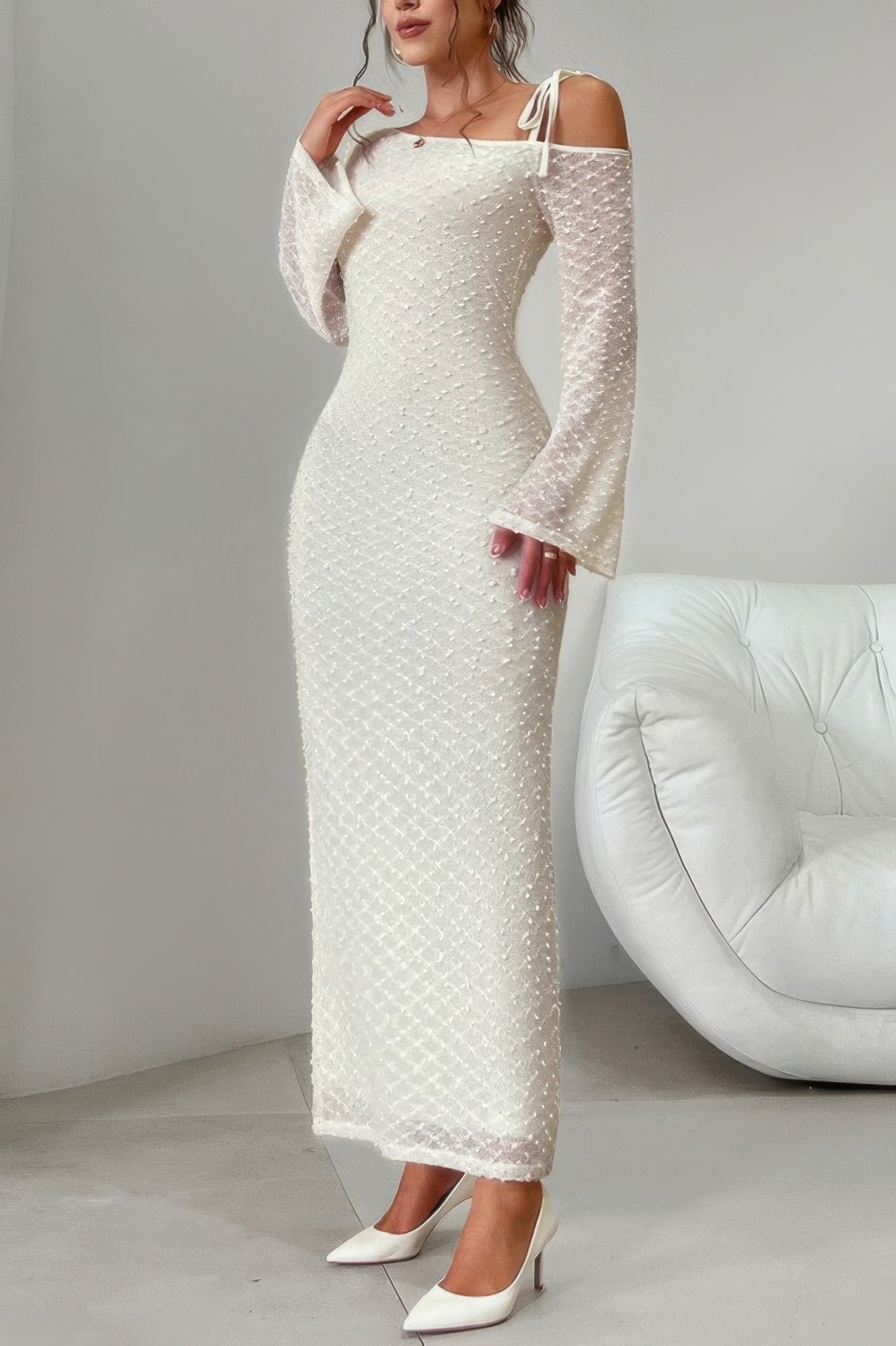 Beige Golden Heir off-shoulder sculpt bodycon midi dress displayed on a model, highlighting its fitted design and elegant style.