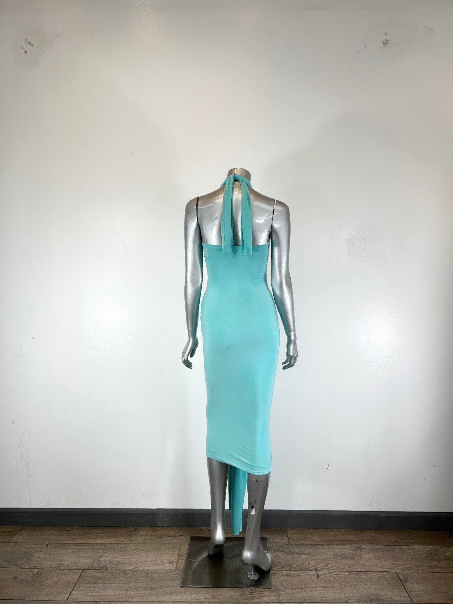 Mint green halter style bodycon midi dress by Golden Heir, form-fitting design with sleek silhouette and stylish neckline.