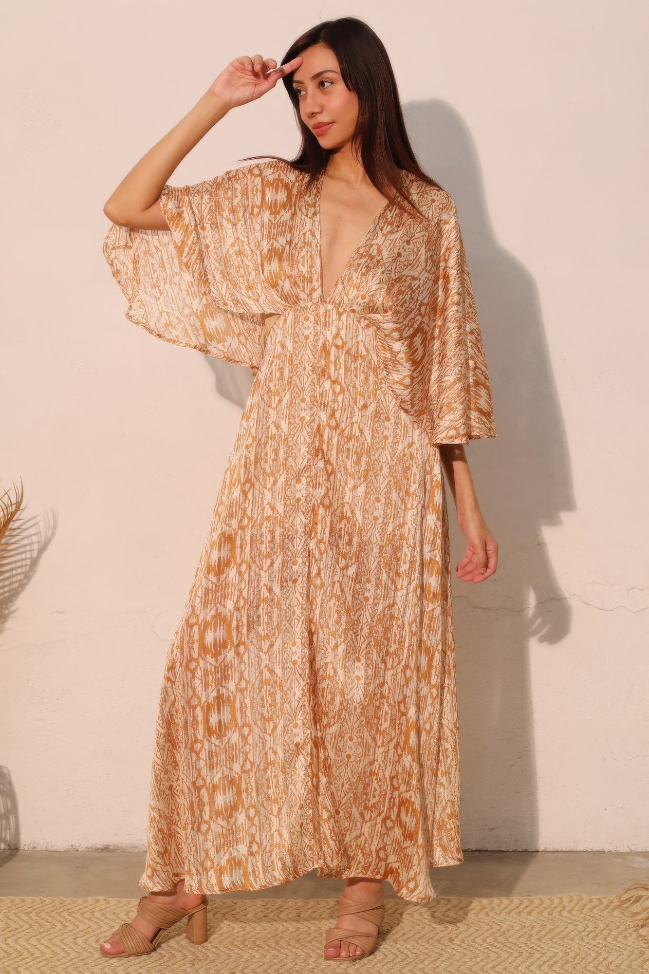 Golden Heir bohemian lurex chiffon cape maxi dress shown in a flowing gold and black design with intricate details.