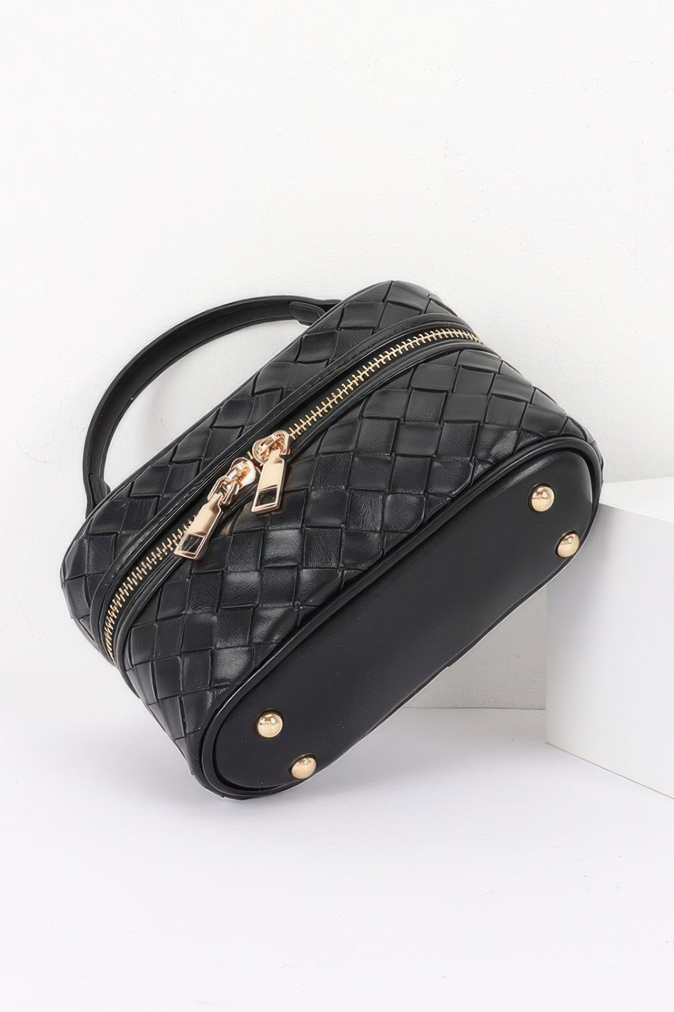 Golden Heir embossed vegan leather crossbody bag in black with gold accents, featuring a compact vanity style for stylish organization.