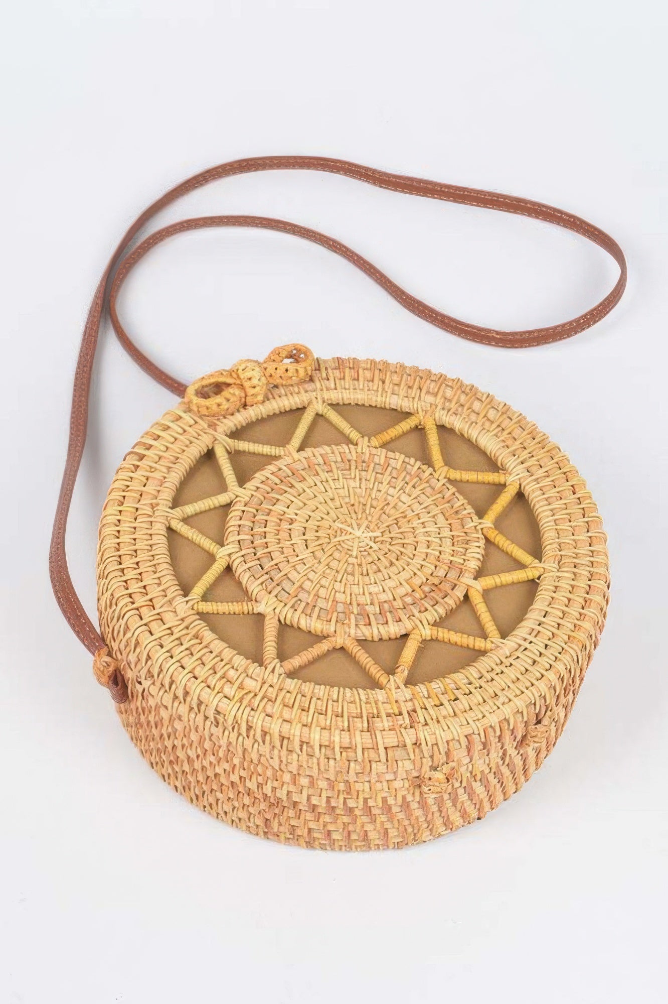 Golden Heir bamboo round crossbody bag with natural finish, showcasing woven bamboo design and adjustable strap.