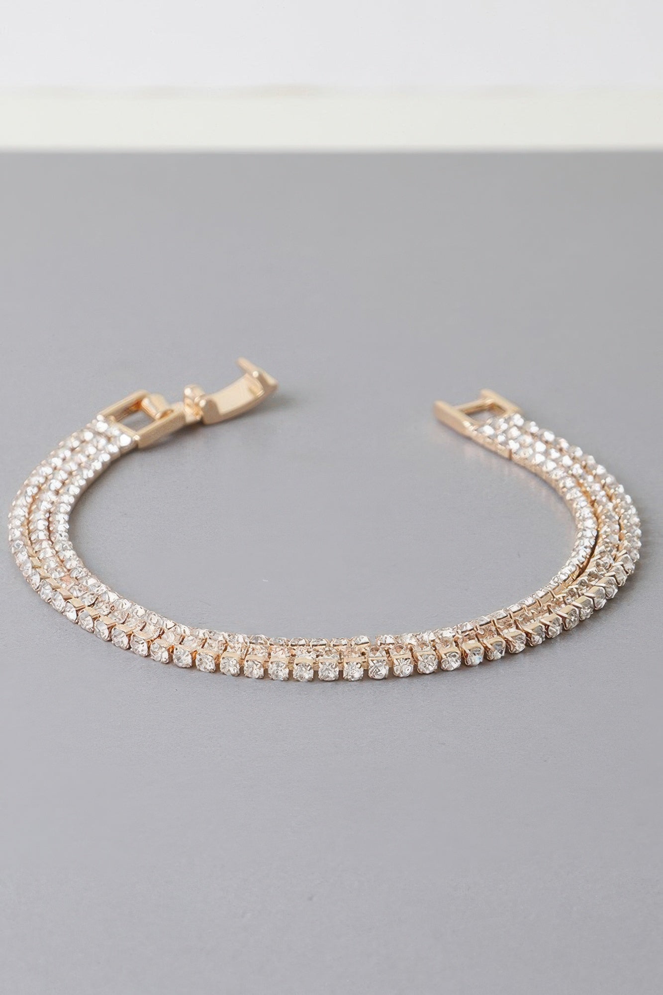 Golden Heir triple cubic jewel bracelet with silver and gold tones featuring sparkling cubic stones on a sleek bracelet.