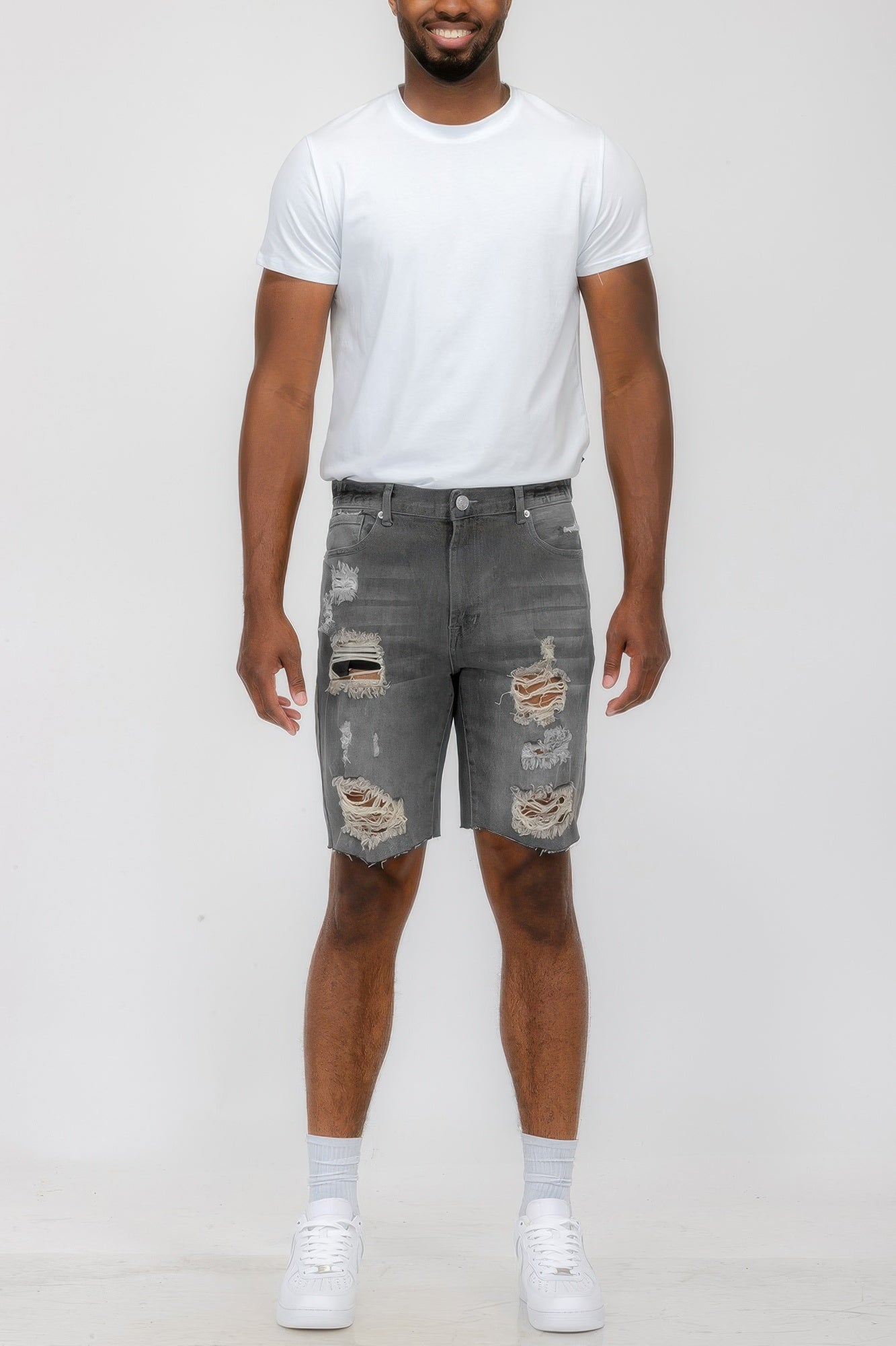 Golden Heir distressed stretch denim shorts in black, showcasing a fitted style with frayed hem and casual design.