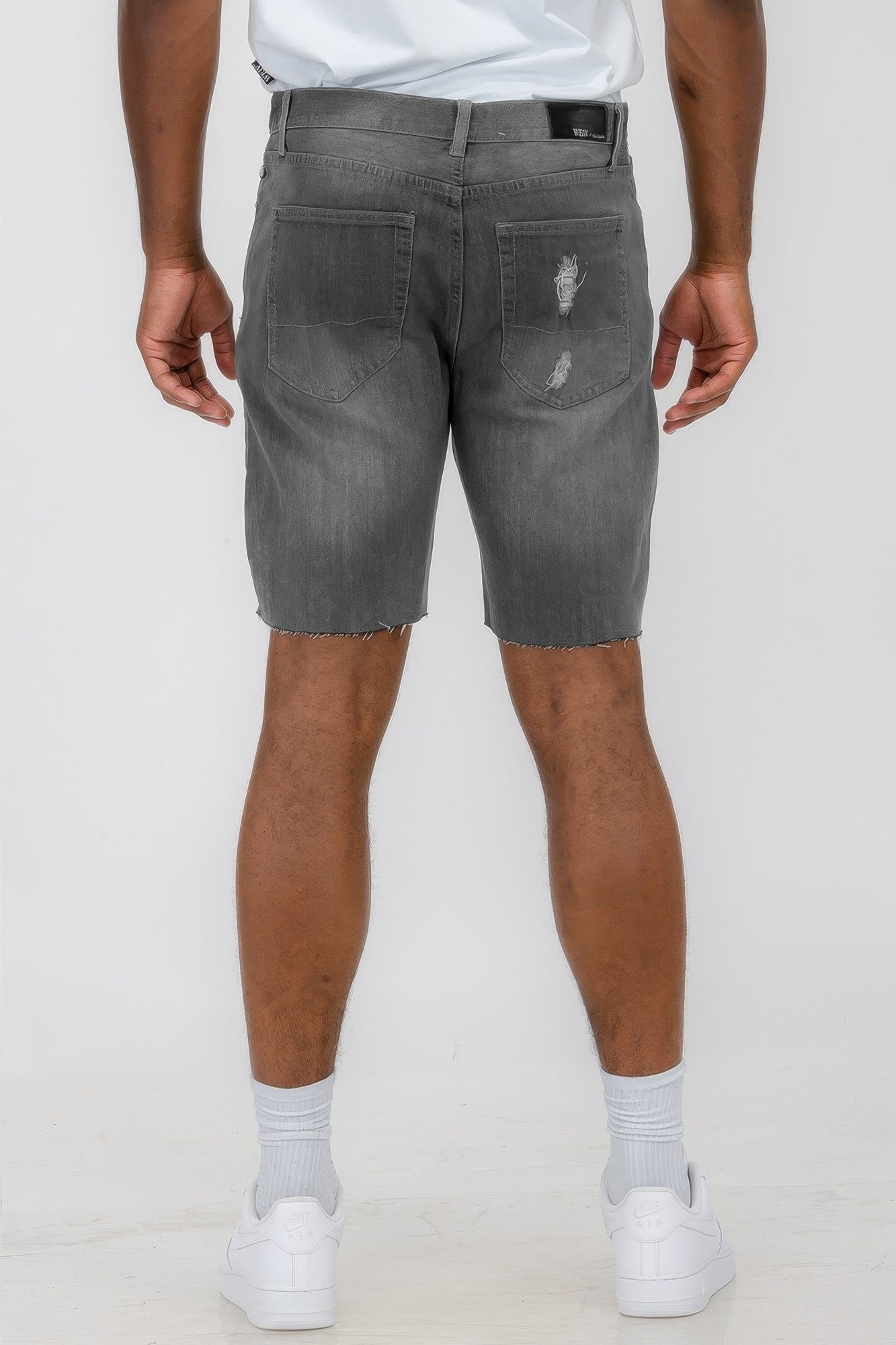 Black distressed stretch denim shorts by Golden Heir, featuring a casual fit and frayed hem for a stylish summer look.