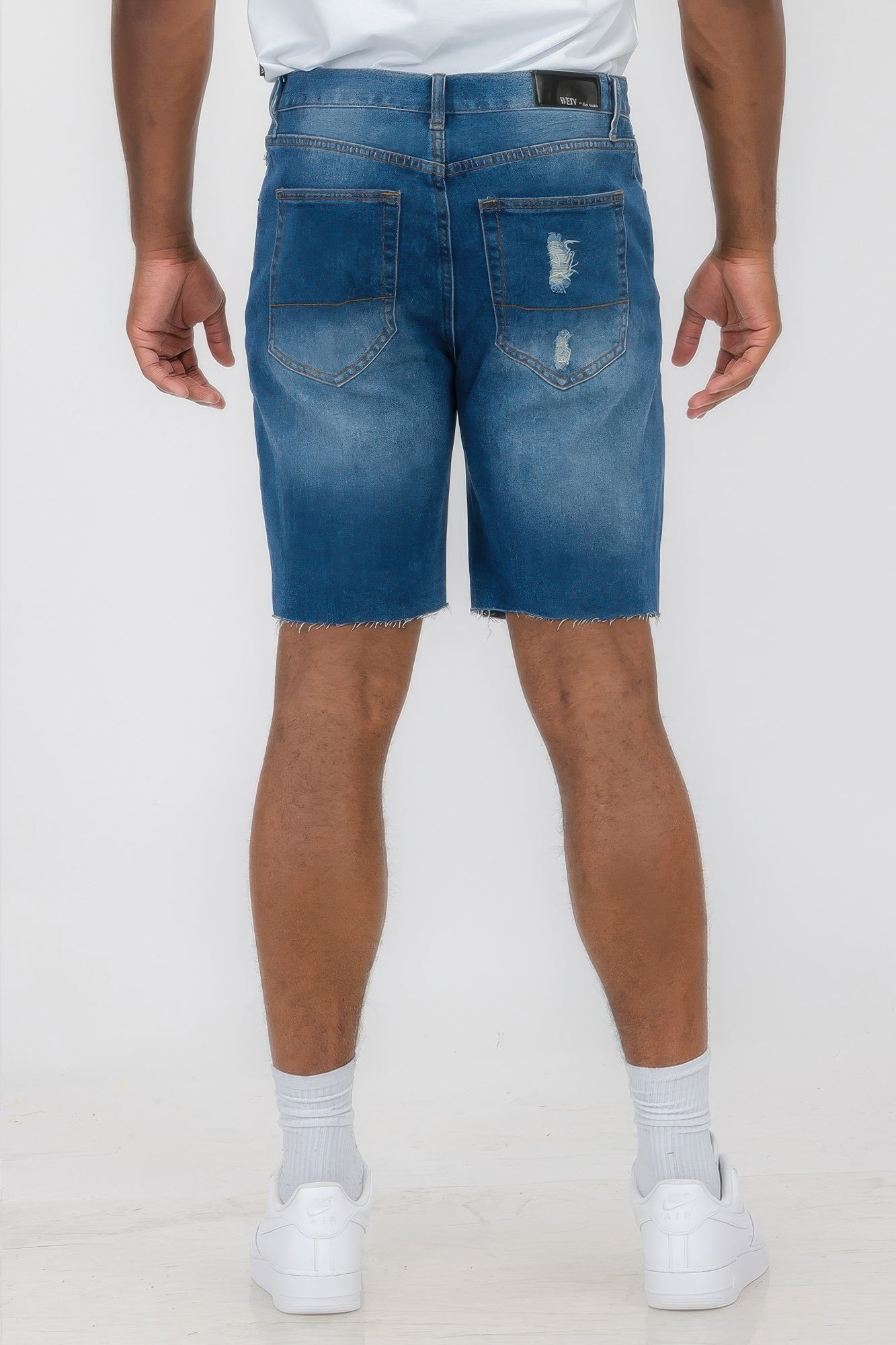 Golden Heir distressed stretch denim shorts in black, featuring a fitted style and frayed hem, perfect for casual wear.
