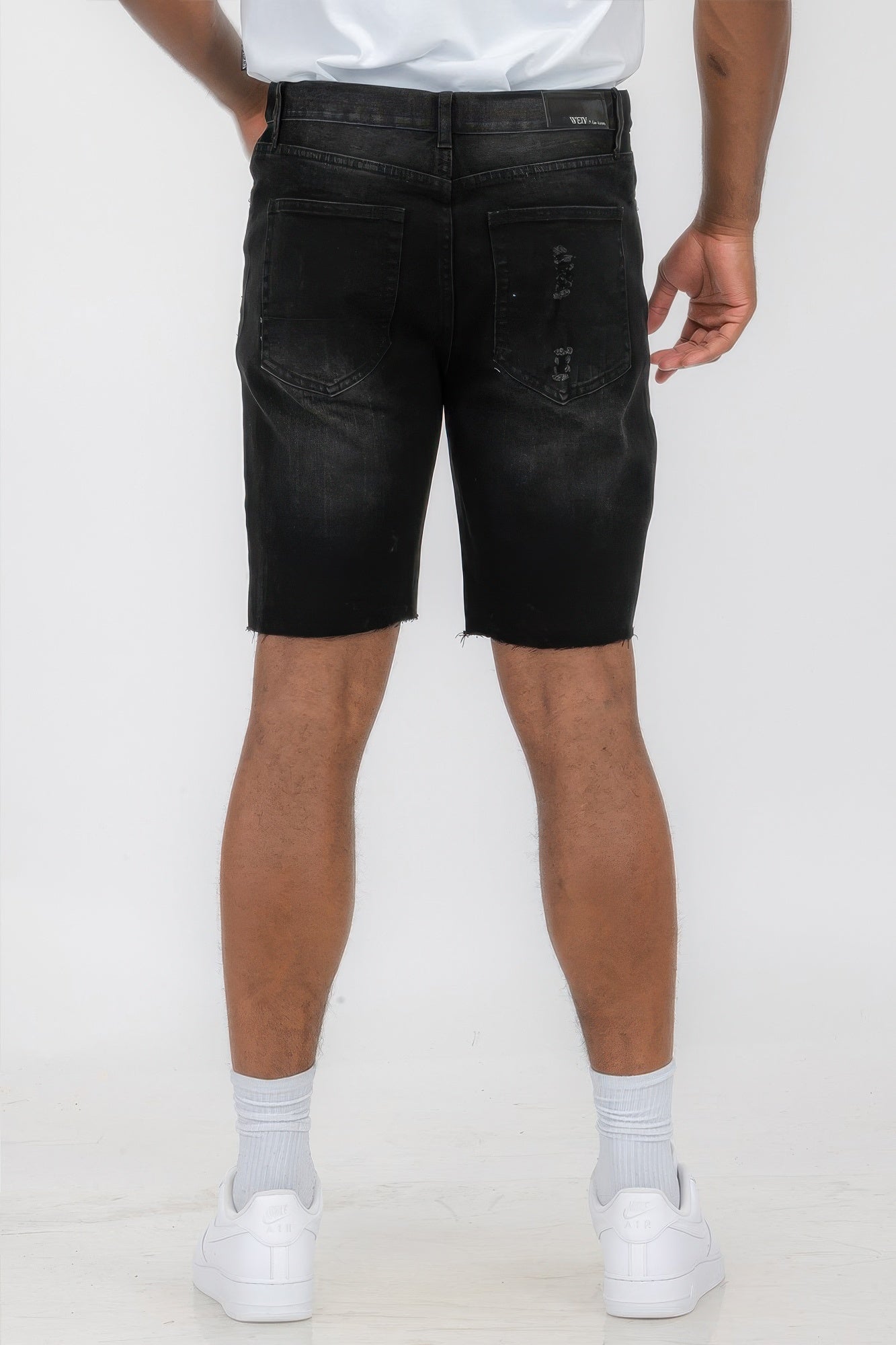 Golden Heir distressed stretch denim shorts in black, featuring a casual fit and stylish frayed hem.