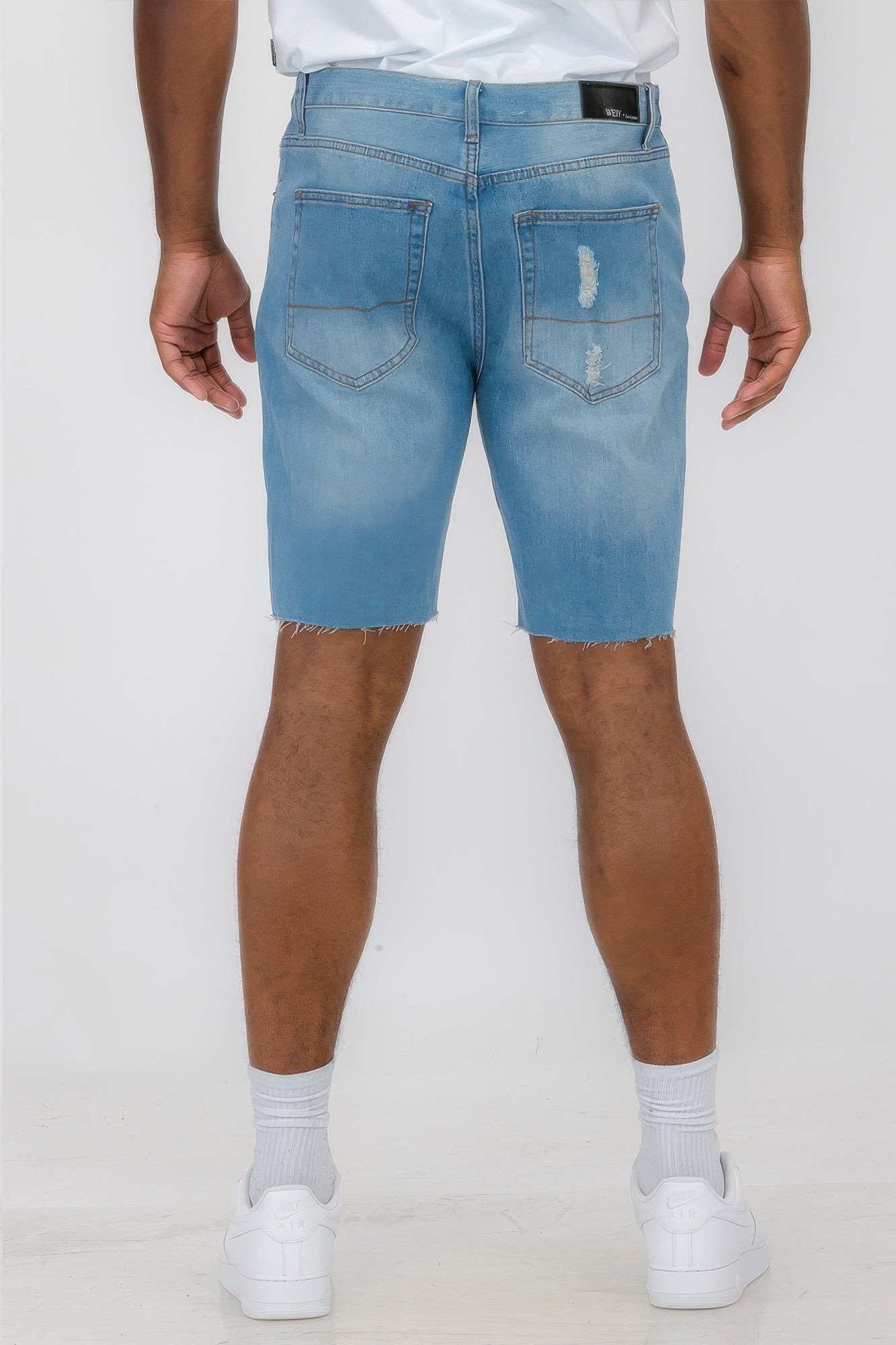 Golden Heir distressed stretch denim shorts in black, featuring a casual fit and frayed hem detail.