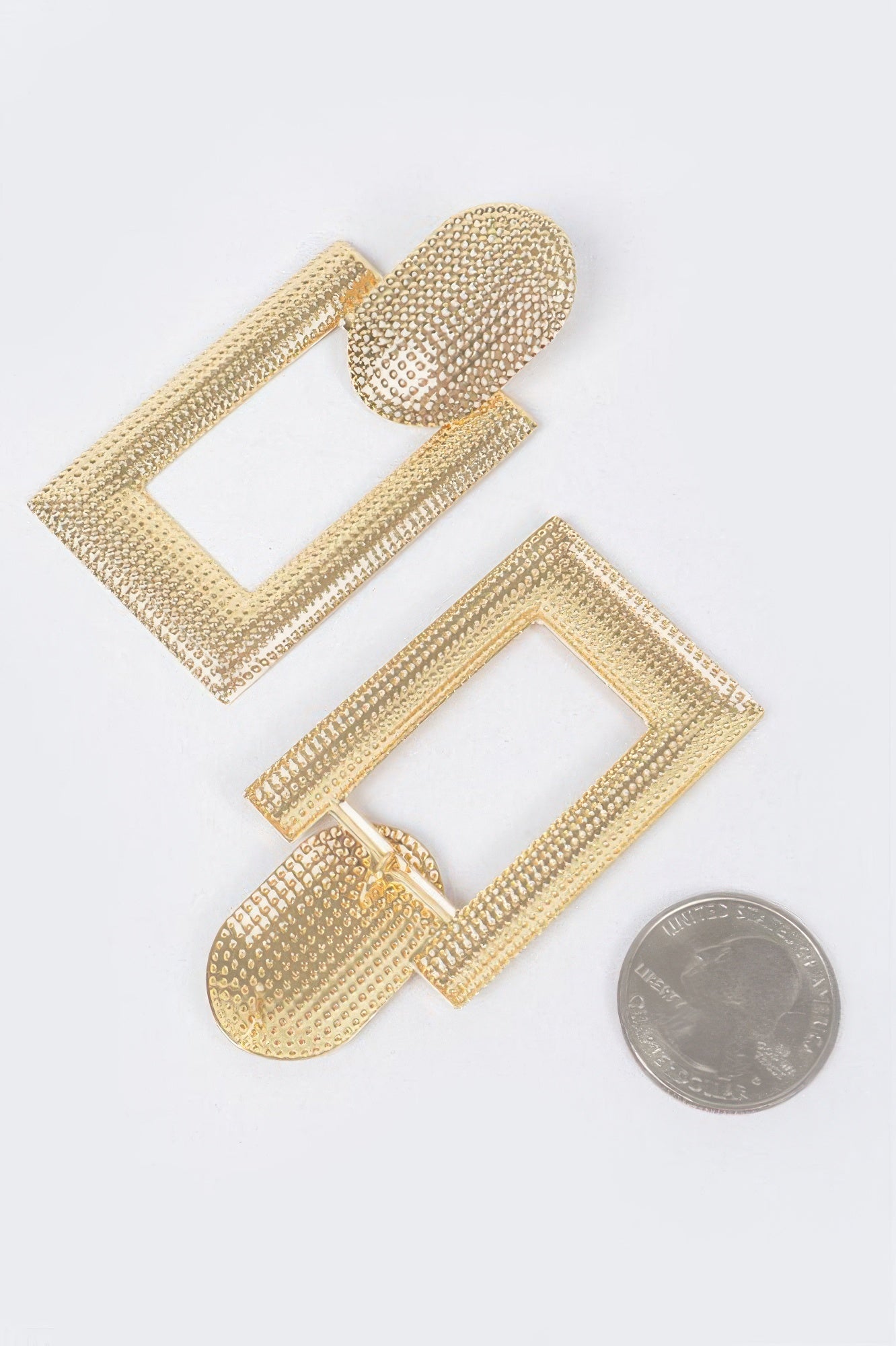 Golden Heir chic gold drop earrings with bold statement design, featuring elegant curves and a polished finish.