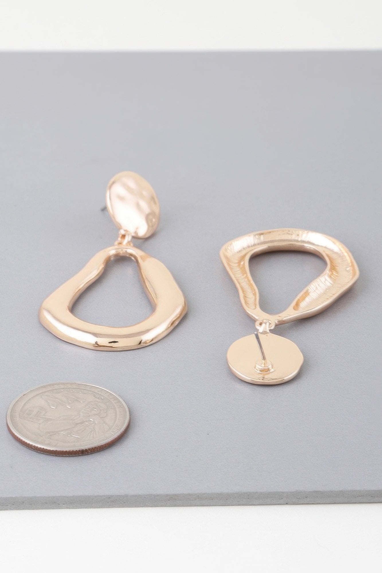 Golden Heir abstract shiny teardrop drop earrings in gold and silver with a sleek, modern design.
