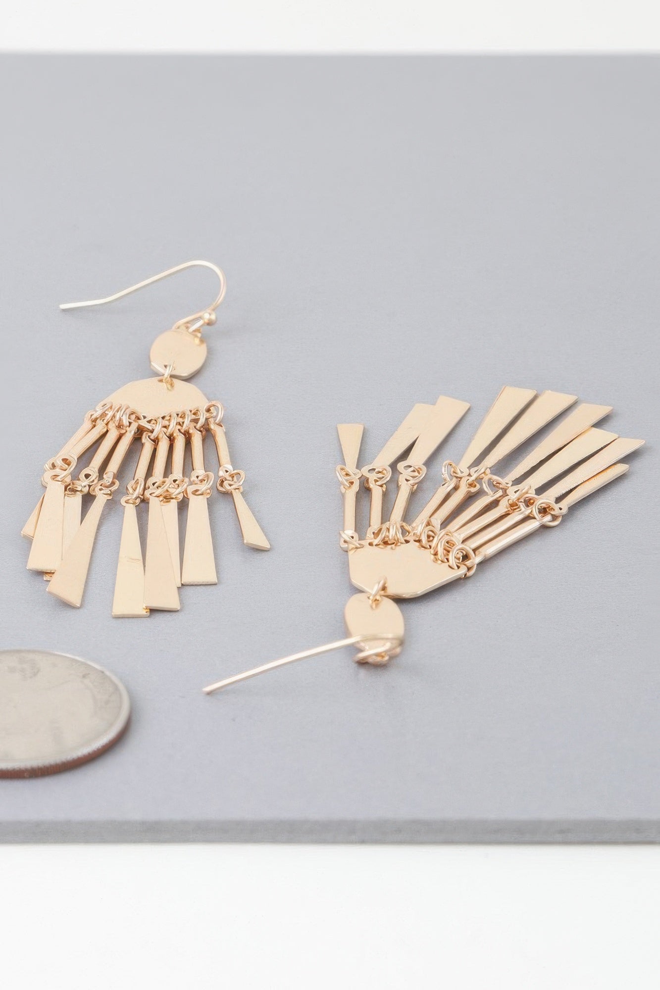 Golden Heir shiny dreamcatcher drop earrings with intricate golden and silver details, hanging elegantly.