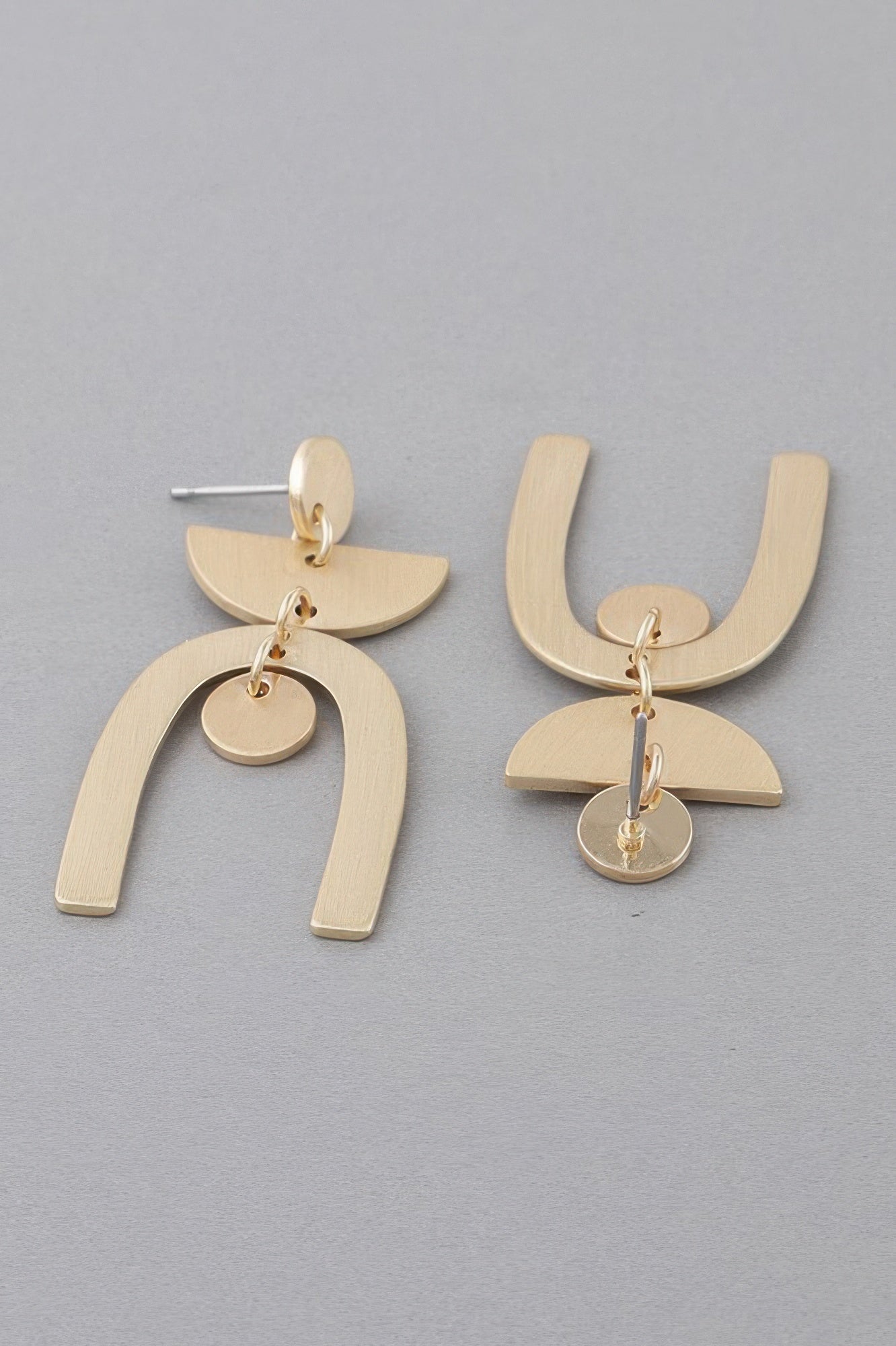 Golden Heir multi-shape gold arch drop earrings featuring geometric designs and polished finishes.