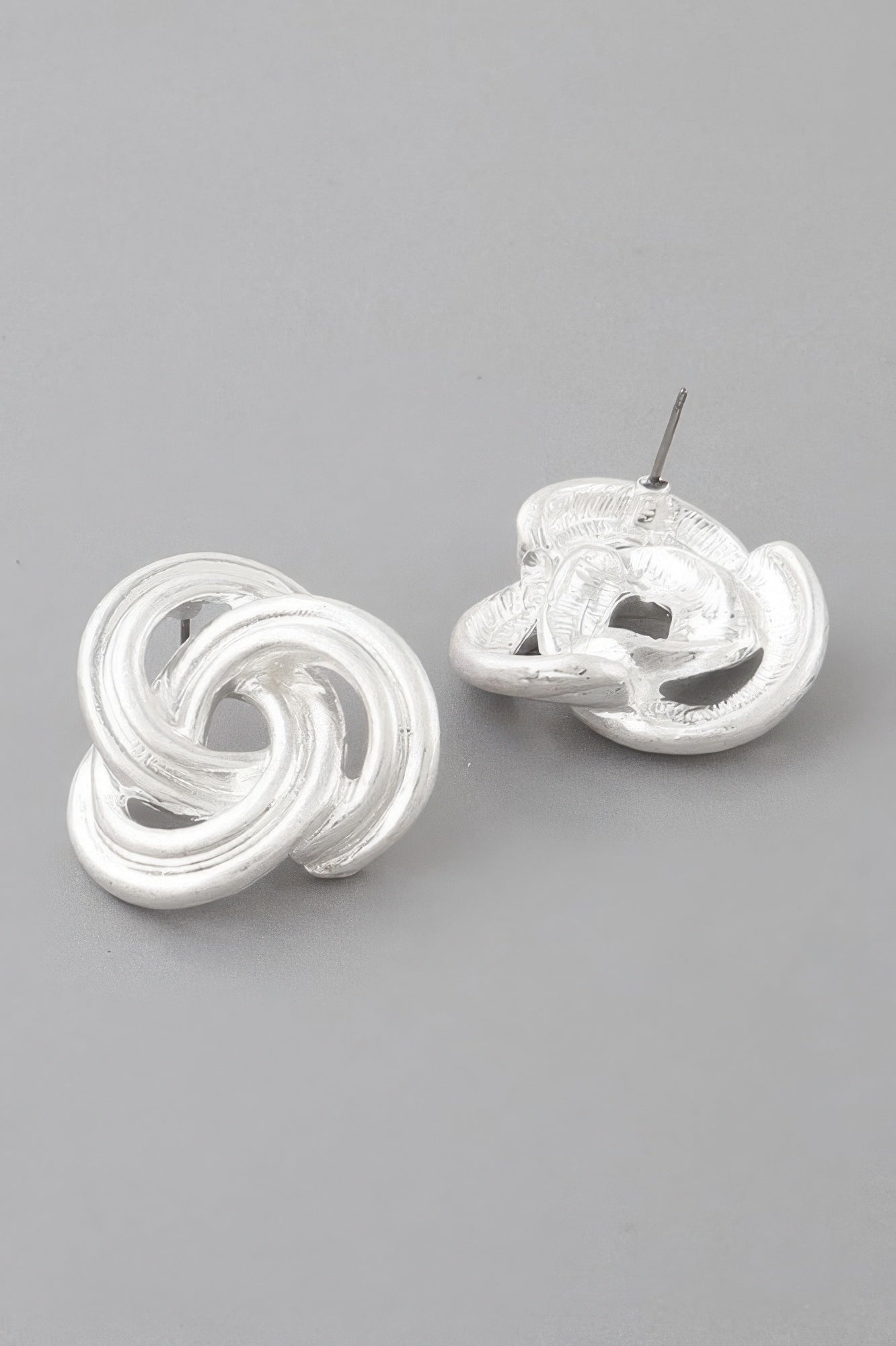 Golden Heir triple-lined knot stud drop earrings in gold, featuring a sleek, elegant design with layered knot details.