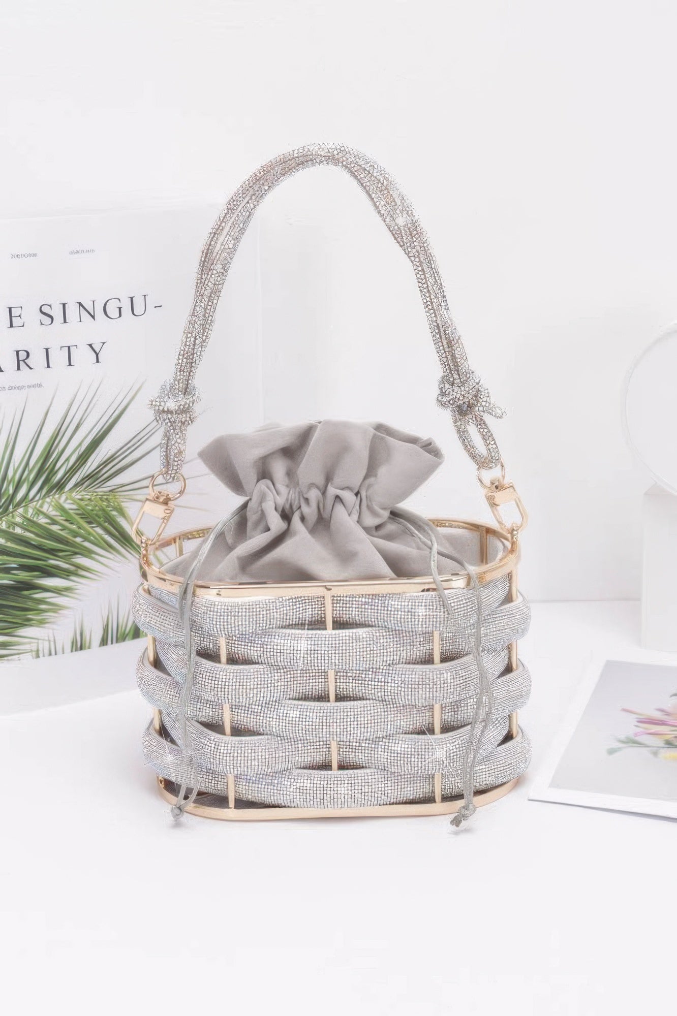 Golden Heir crystal braided metal bucket handbag with black accents, featuring a stylish, intricate design and sturdy metal handle.