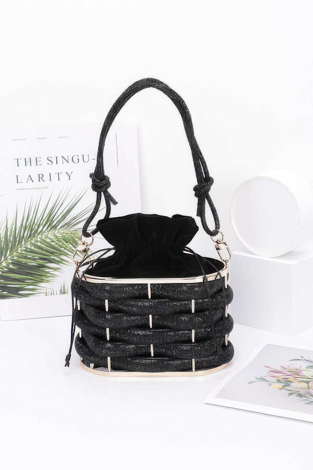 Golden Heir crystal braided metal bucket handbag with black accents, featuring a stylish and elegant design for women.