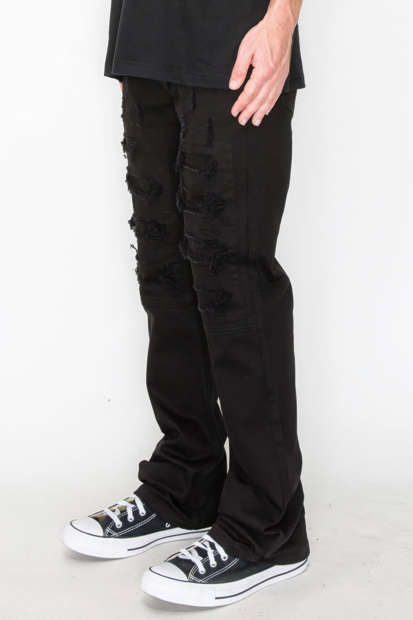 Golden Heir bootcut rip and repair colored jeans featuring distressed details and a relaxed fit, shown on a model.