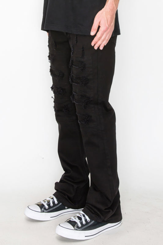 Golden Heir bootcut rip and repair colored jeans featuring distressed details and a relaxed fit, shown on a model.