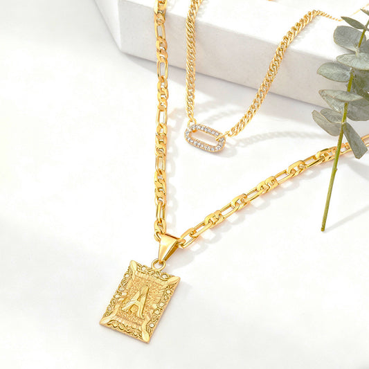 Golden Heir double-layer gold necklace featuring 26 letter pendants and zircon circle accents on a jewelry display.