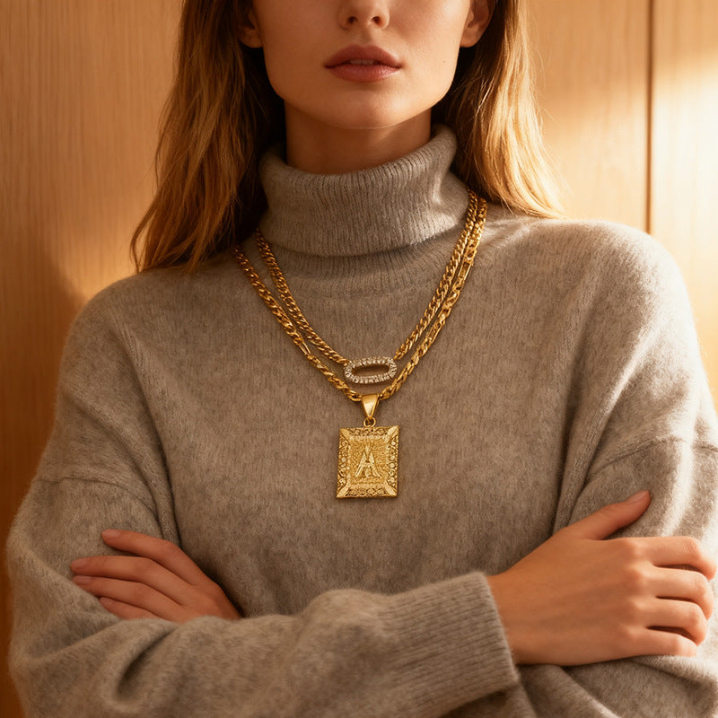 Golden Heir double-layer gold necklace with 26-letter pendant and zircon circle accents, elegant jewelry piece.