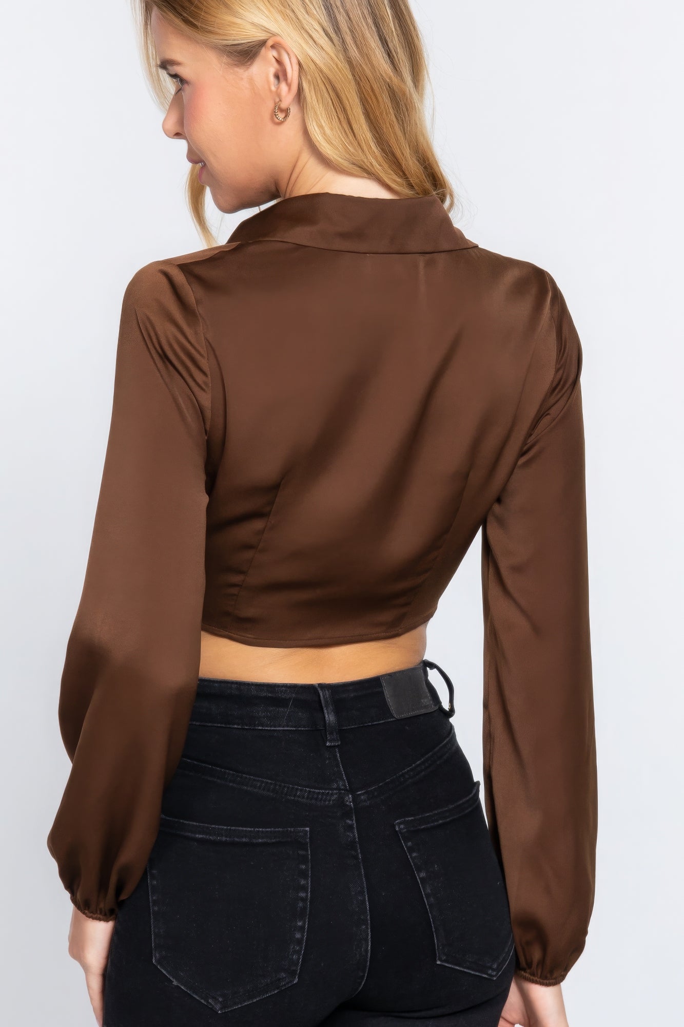 Golden Heir long sleeve twist top with notched collar, stylish and fitted, shown in a natural pose.