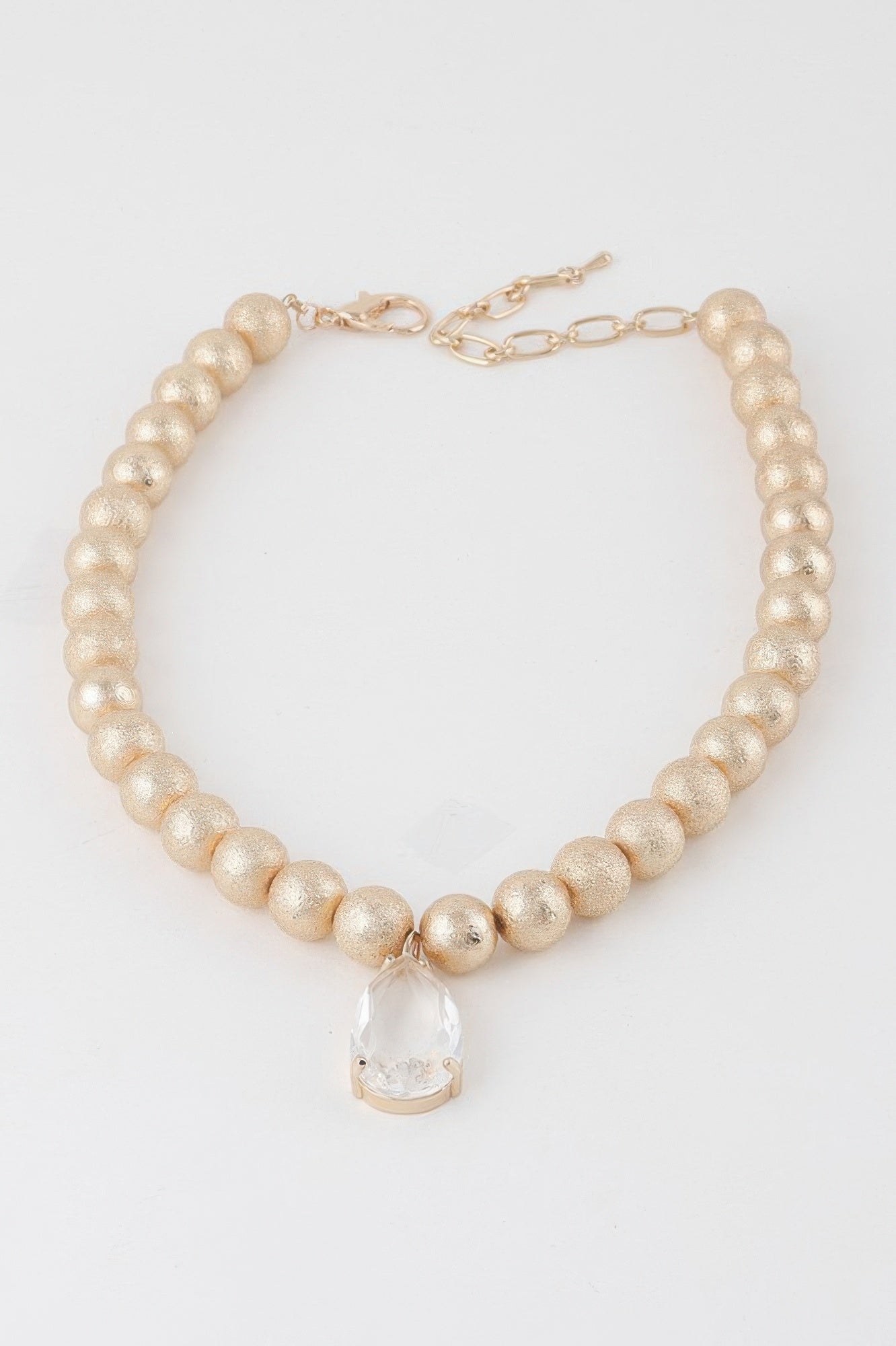 Golden Heir clear teardrop beaded necklace with gold accents, featuring elegant teardrop-shaped beads on a delicate chain.