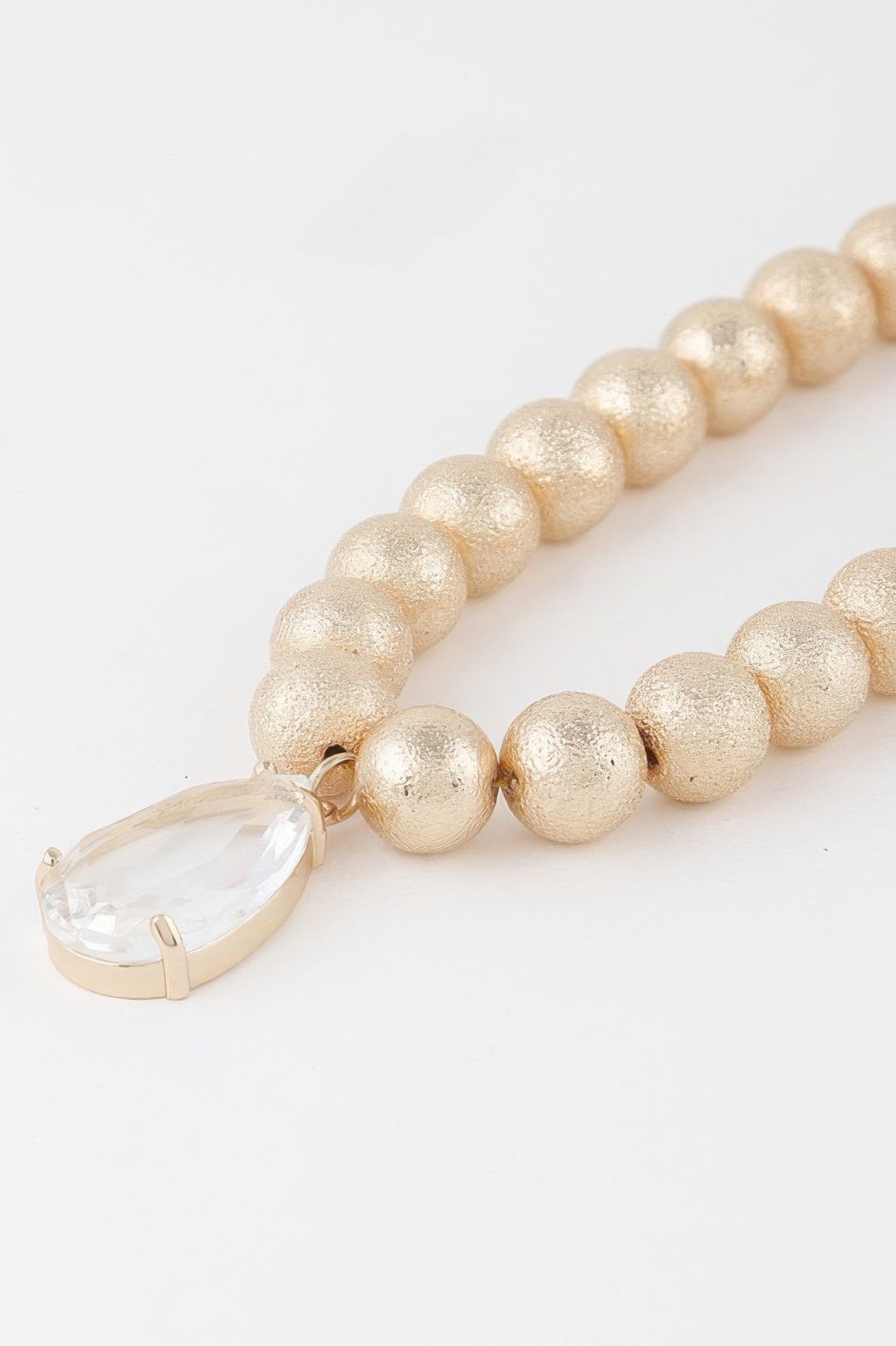 Golden Heir clear teardrop beaded necklace featuring gold accents, elegant and lightweight jewelry design.