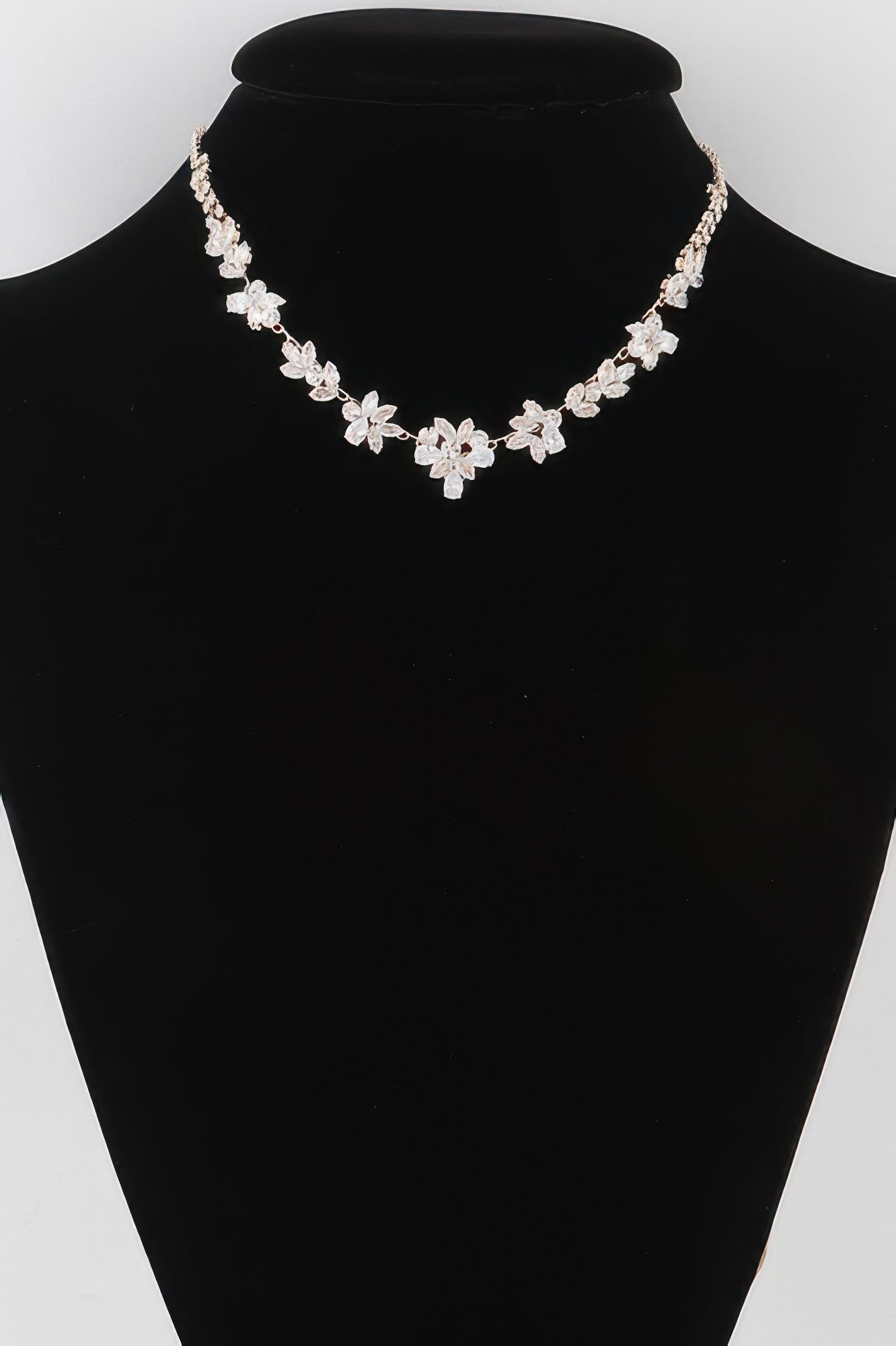 Golden Heir crystal flower charm necklace with a gold chain and clear crystal flower pendant, elegant jewelry accessory.