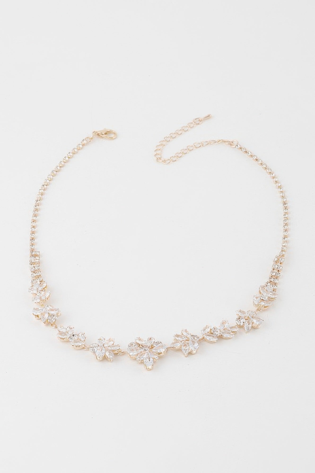 Golden Heir crystal flower charm necklace featuring a gold chain and clear crystal flower pendant.