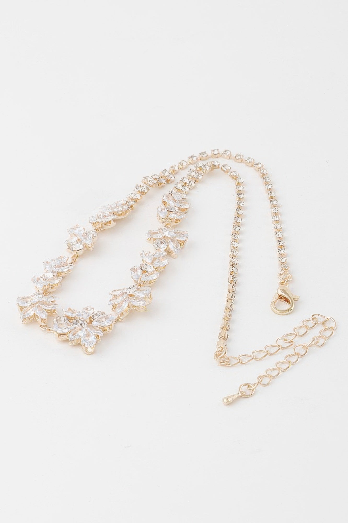 Golden Heir crystal flower charm necklace with a gold chain and clear crystal flower pendant, showcasing elegant jewelry design.