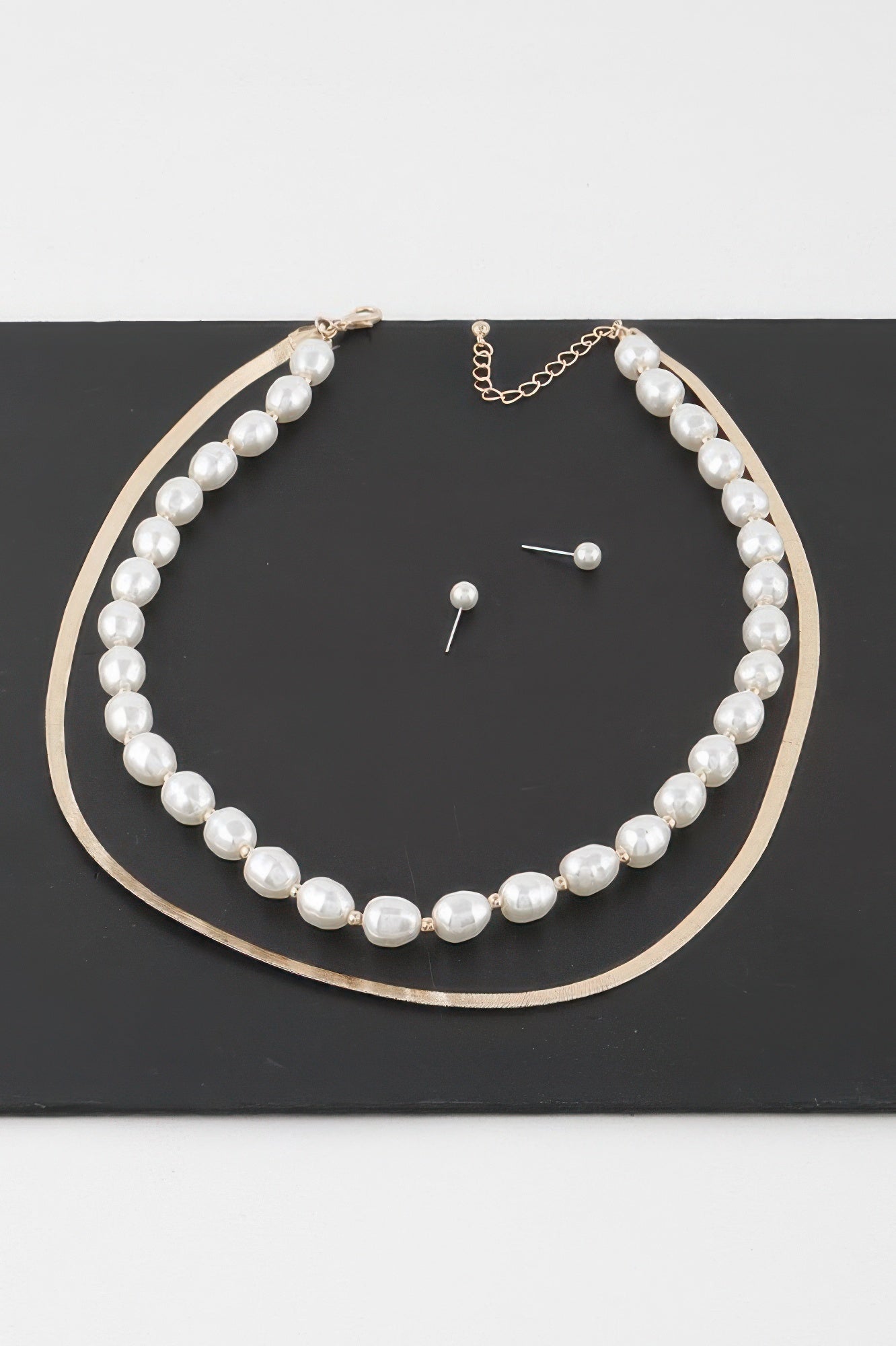 Golden Heir stone snake chain necklace in gold with cream accents, showcasing a sleek and elegant jewelry design.