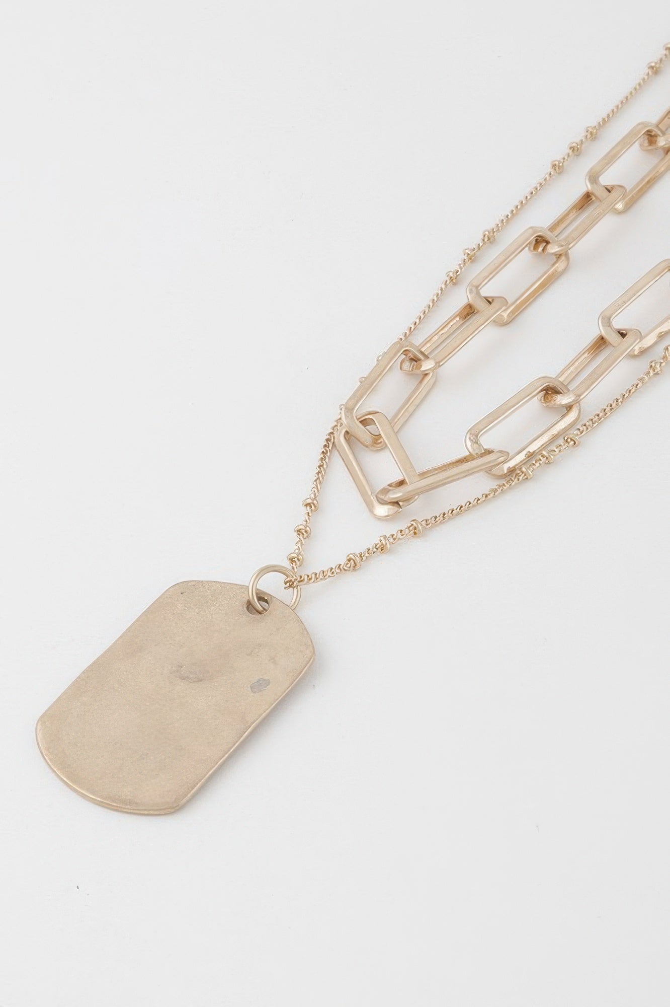 Golden Heir double-layered gold tag chain necklace featuring sleek, stylish design and adjustable length.