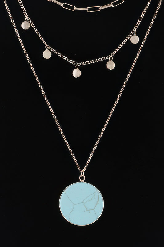 Golden Heir multi-stone pendant chain necklace featuring turquoise and gold stones on a delicate gold chain.