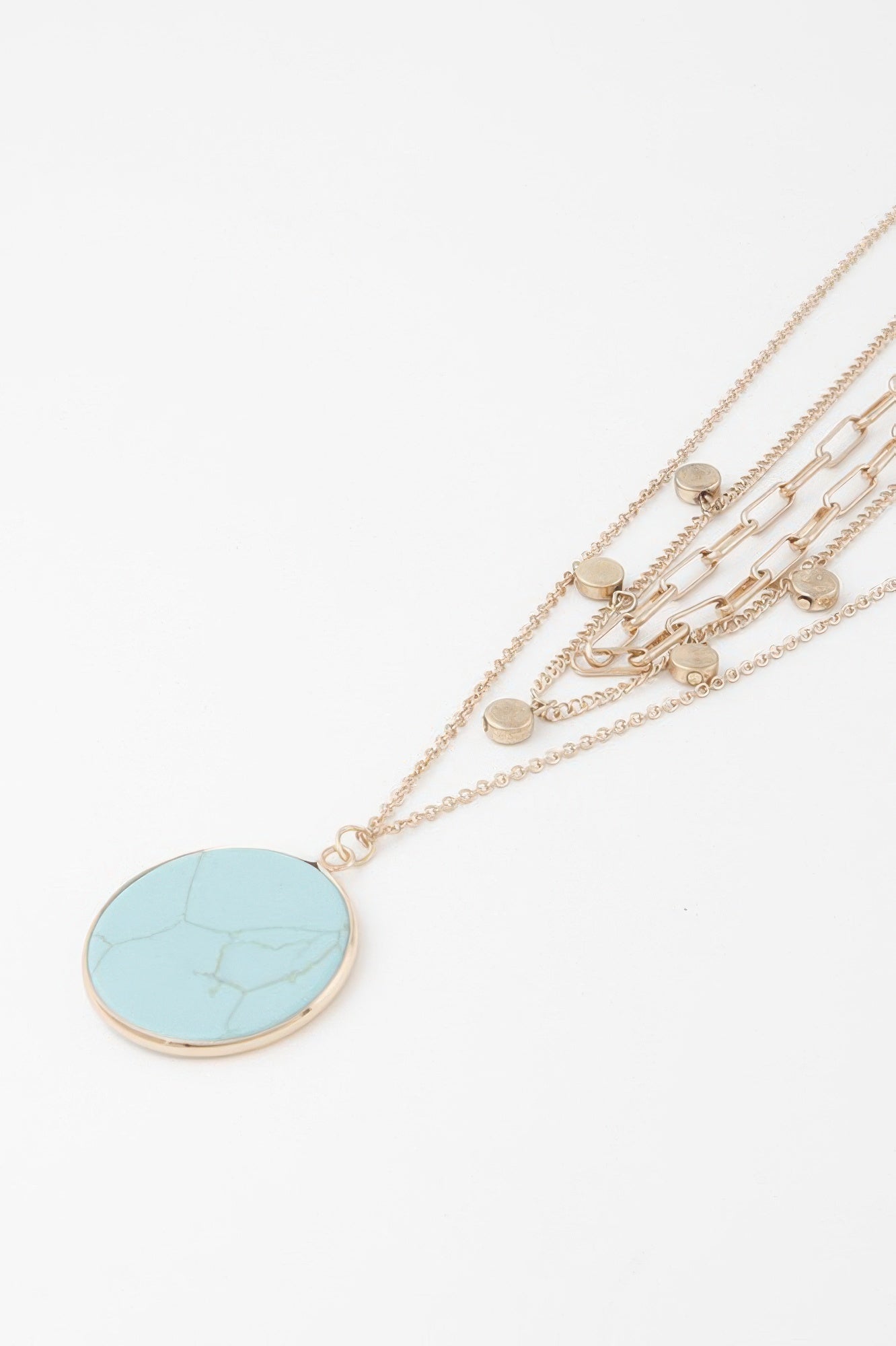 Golden Heir multi-stone pendant chain necklace featuring gold and turquoise stones, showcasing a stylish and elegant jewelry design.