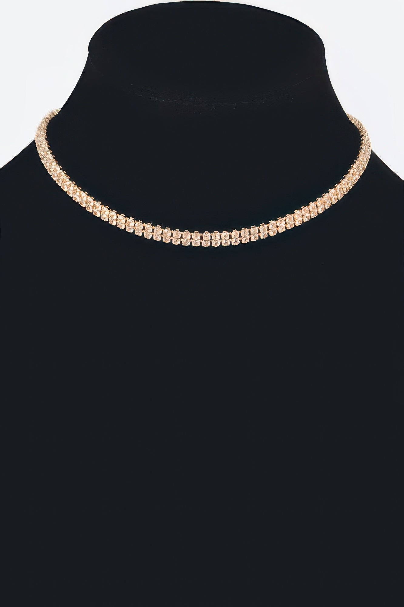 Golden Heir shiny minimal choker necklace with a smooth gold finish, close-up of sleek, elegant jewelry design.