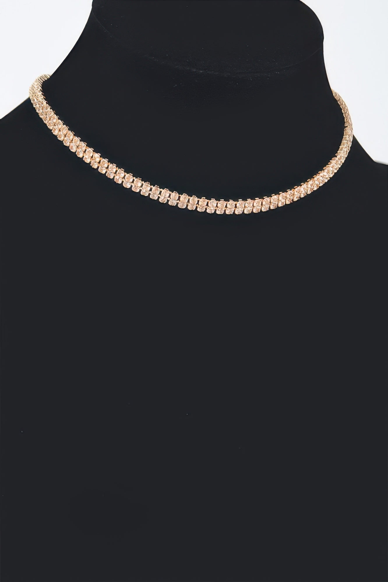 Golden Heir shiny minimal choker necklace featuring a sleek gold design, close-up of the elegant jewelry on a plain background.