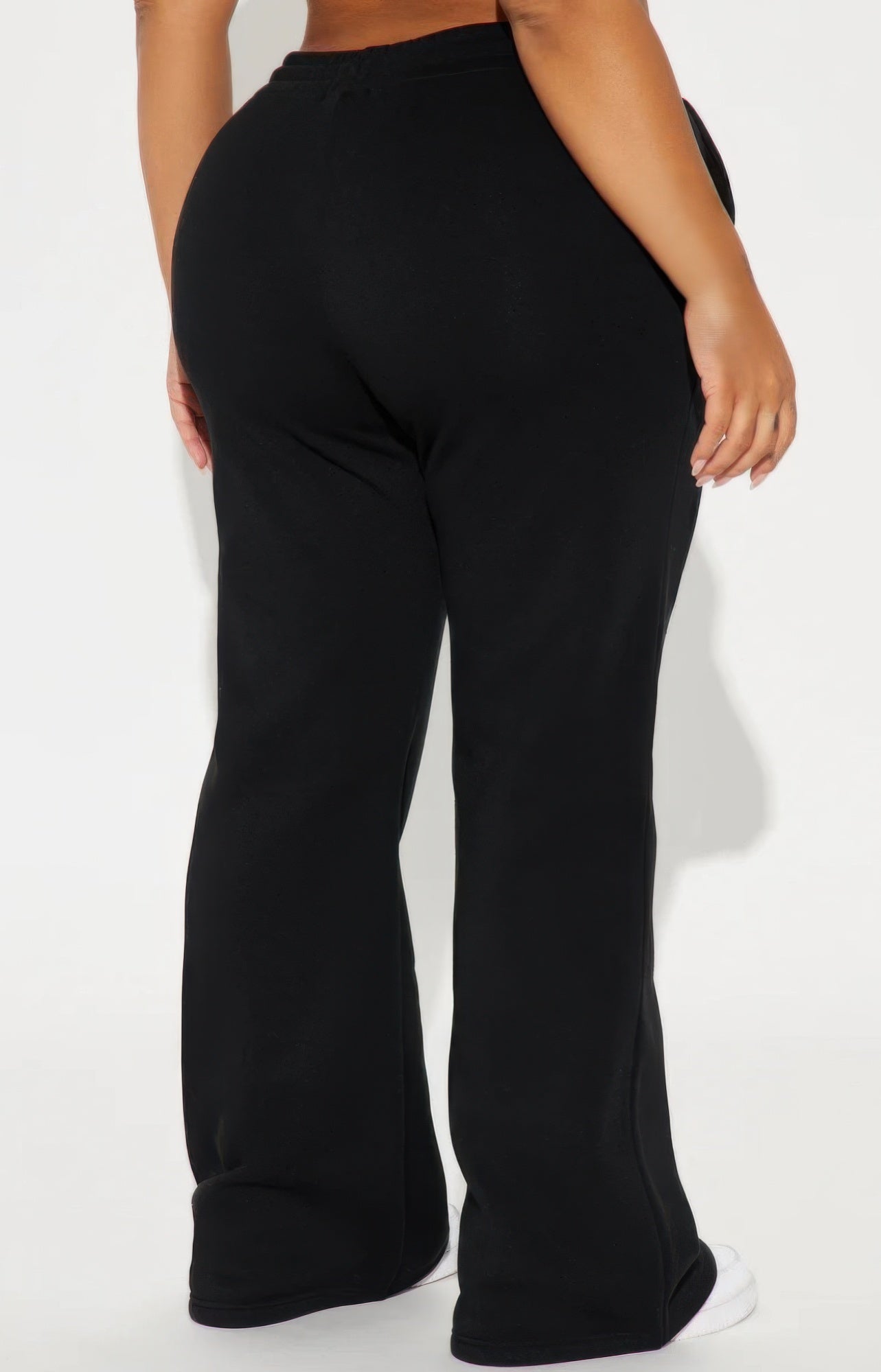 Black lounge flare pants by Golden Heir featuring a relaxed fit and stylish silhouette, shown laid flat.
