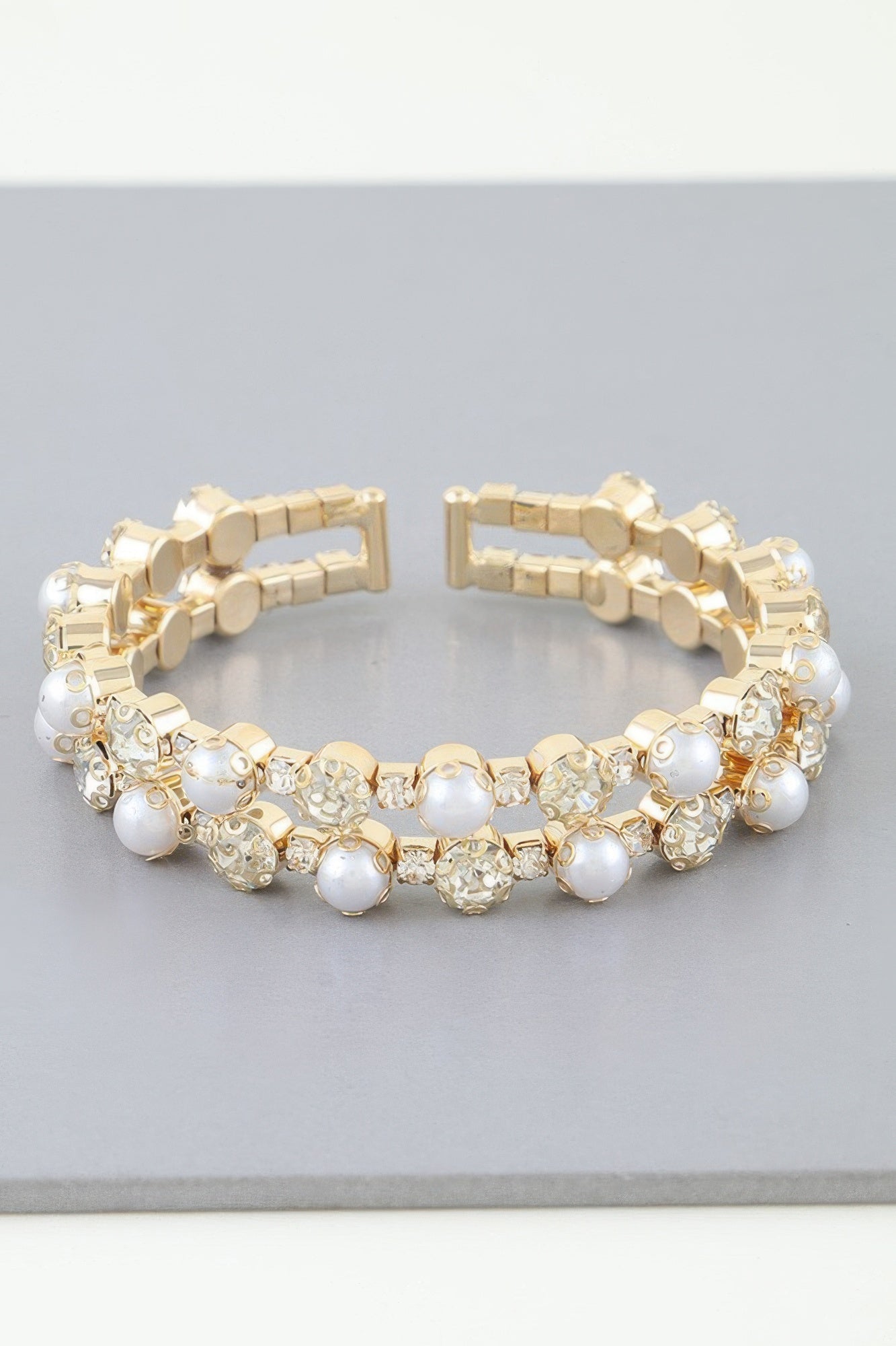 Golden Heir double pearled cuff bracelet featuring silver and golden pearls on a sleek band.