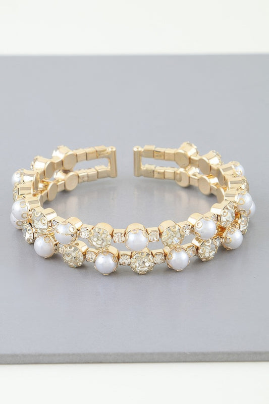 Golden Heir double pearled cuff bracelet featuring silver and golden pearls on a sleek band.