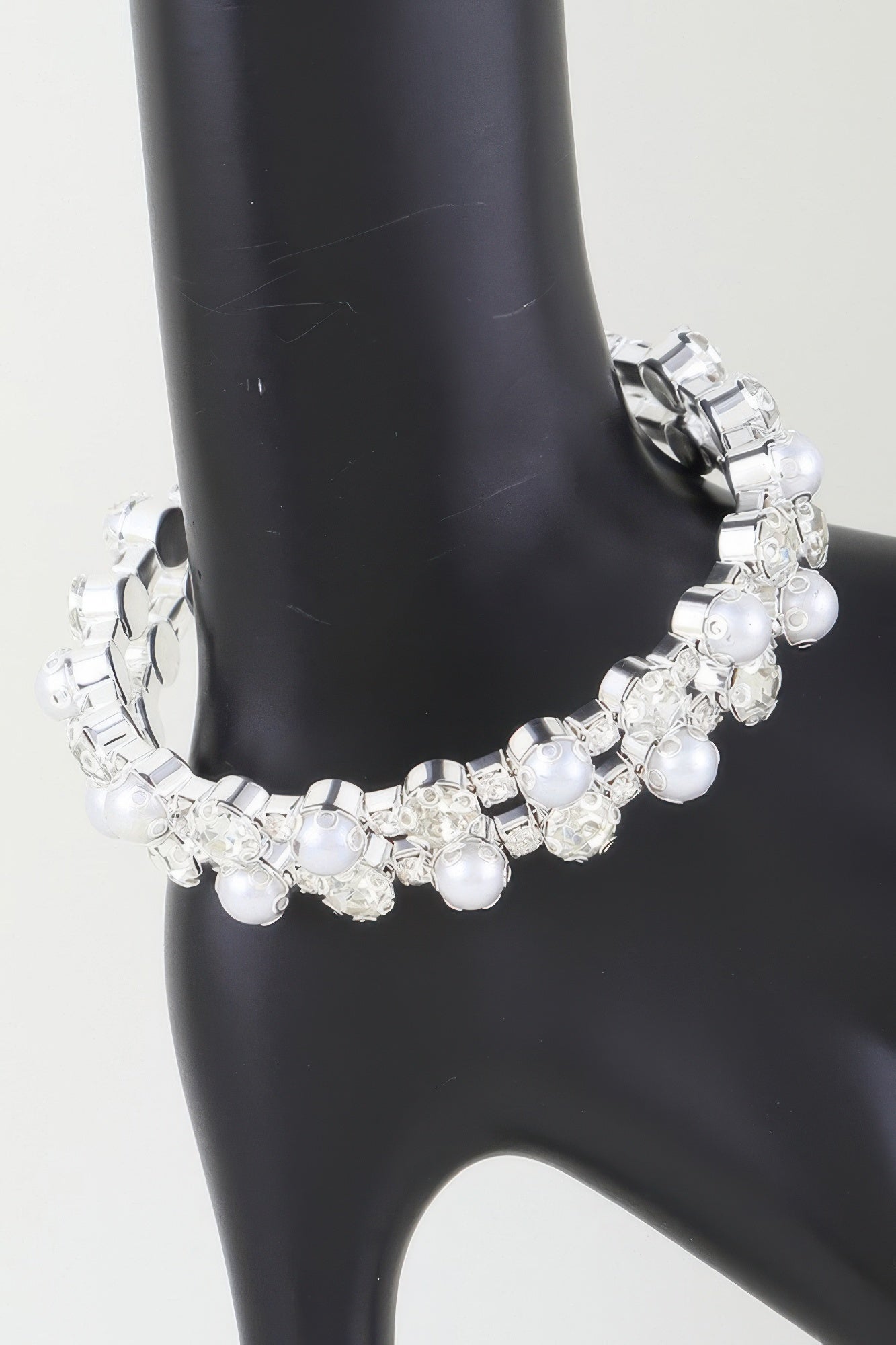 Golden Heir double pearled cuff bracelet featuring silver and gold-toned pearls on a sleek metal band.