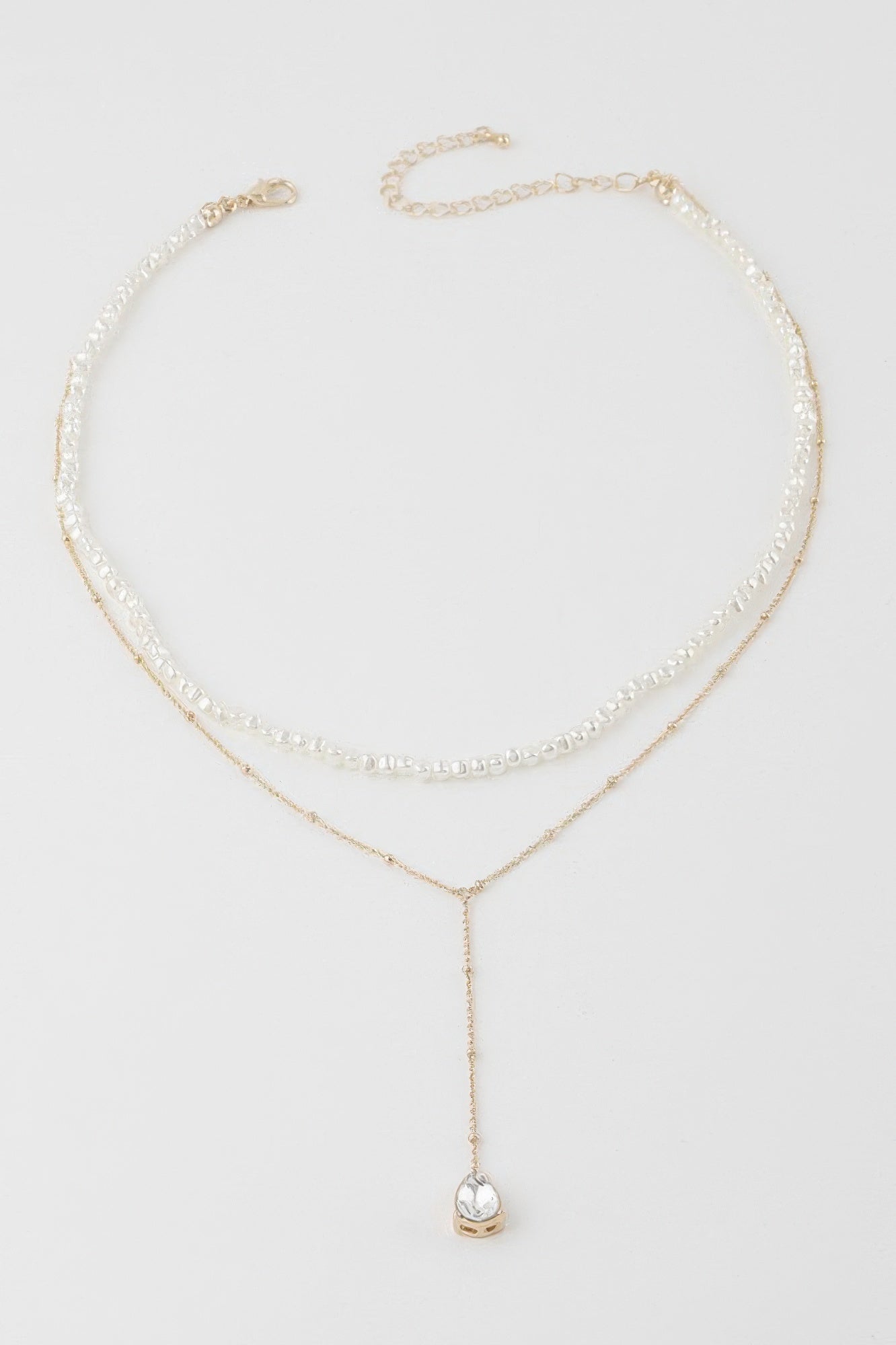 Golden Heir Aurelia double teardrop pearl necklace with cream and gold tones, featuring elegant pearl drops on a delicate chain.